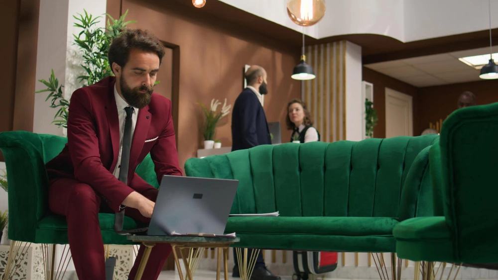 a-man-working-on-a-laptop-in-a-hotel-lobby