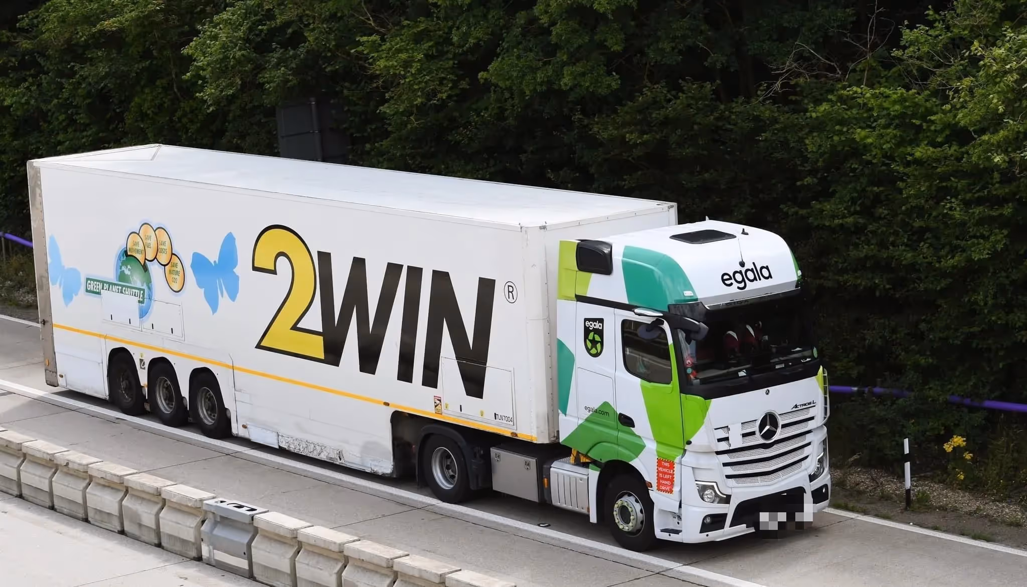Egala by Boekestijn 2WIN truck driving on a highway, featuring green and white design.