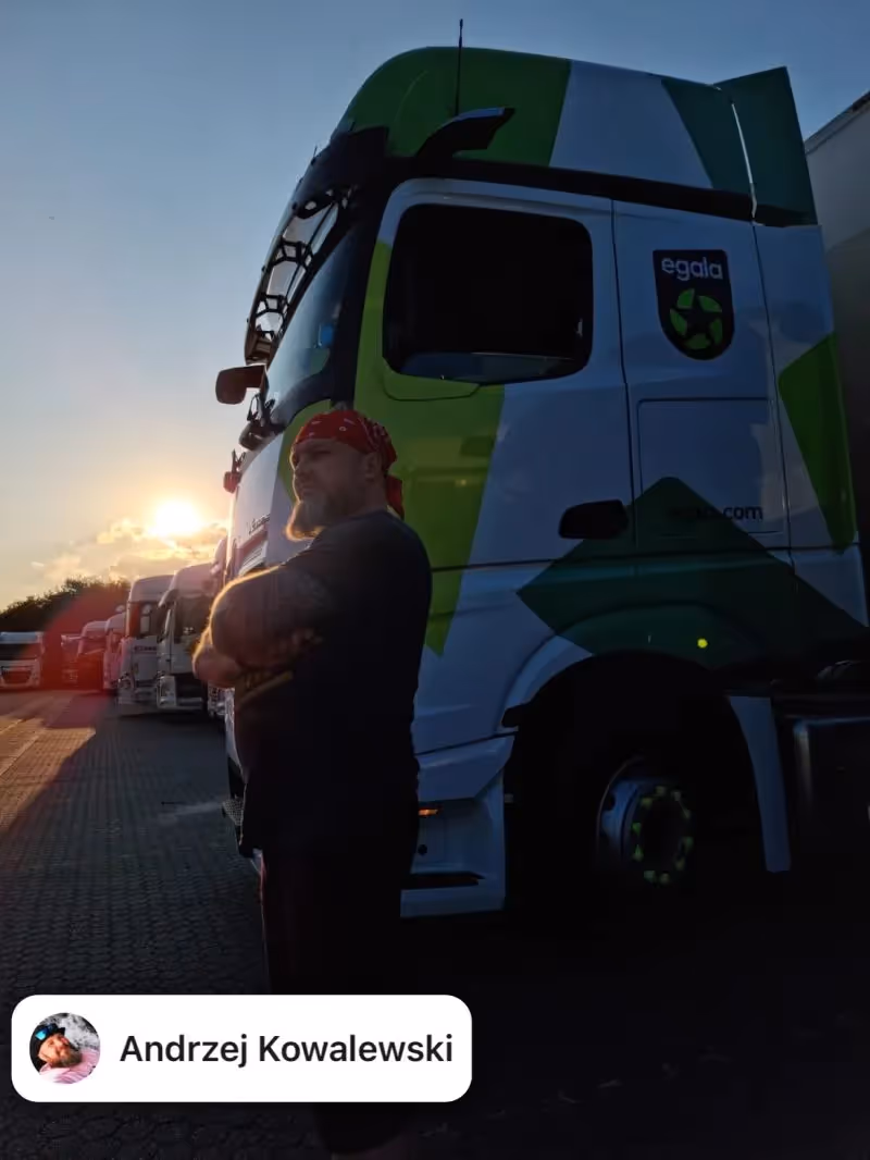 Egala by Boekestijn truck driver standing confidently beside a green and white DAF truck at sunset — symbolizing strength, professionalism, and dedication in European trucking