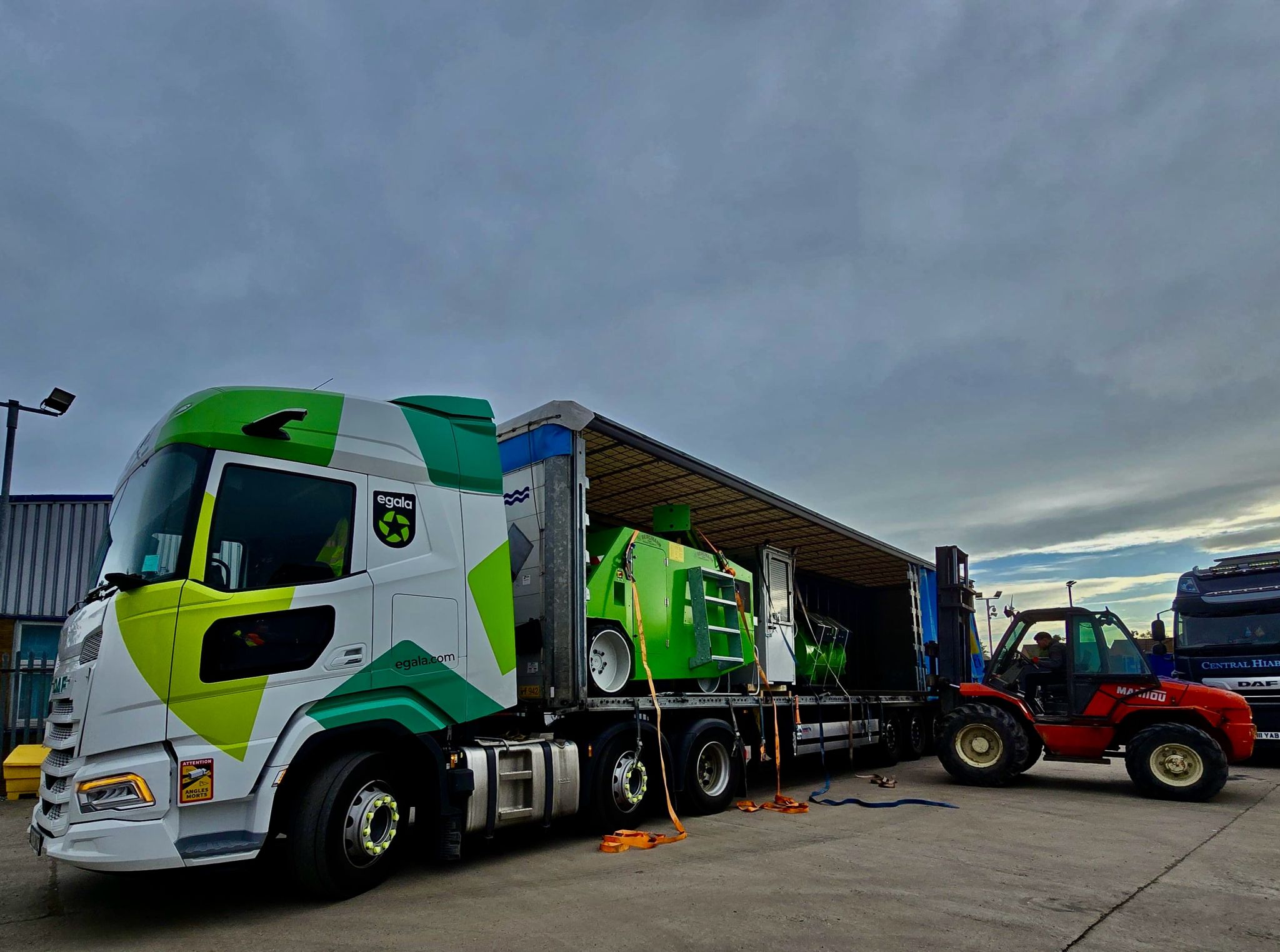 Egala by Boekestijn truck with a green and white cab parked at a loading bay with equipment attached.