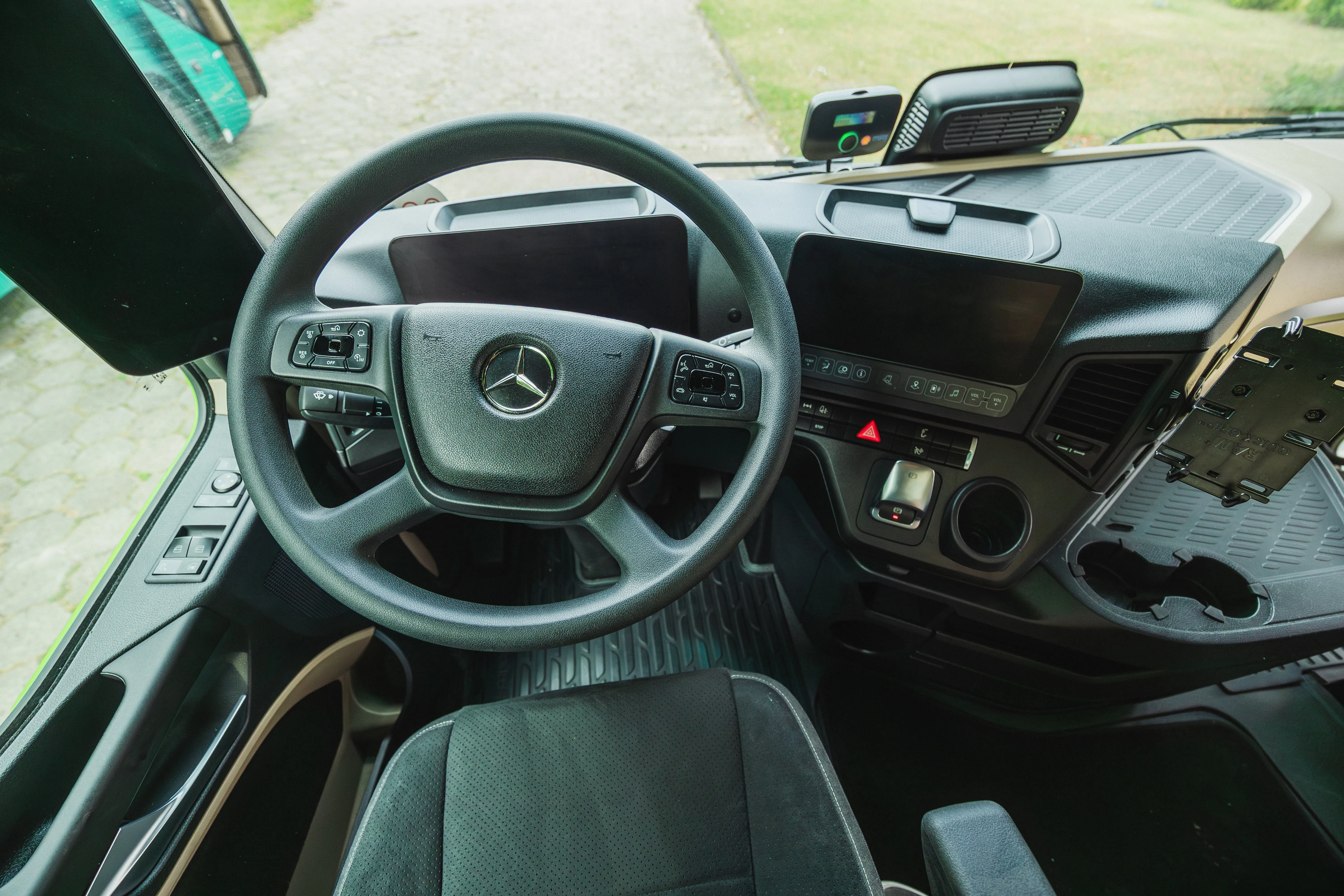 Interior view of a truck cabin showing the steering wheel and dashboard.