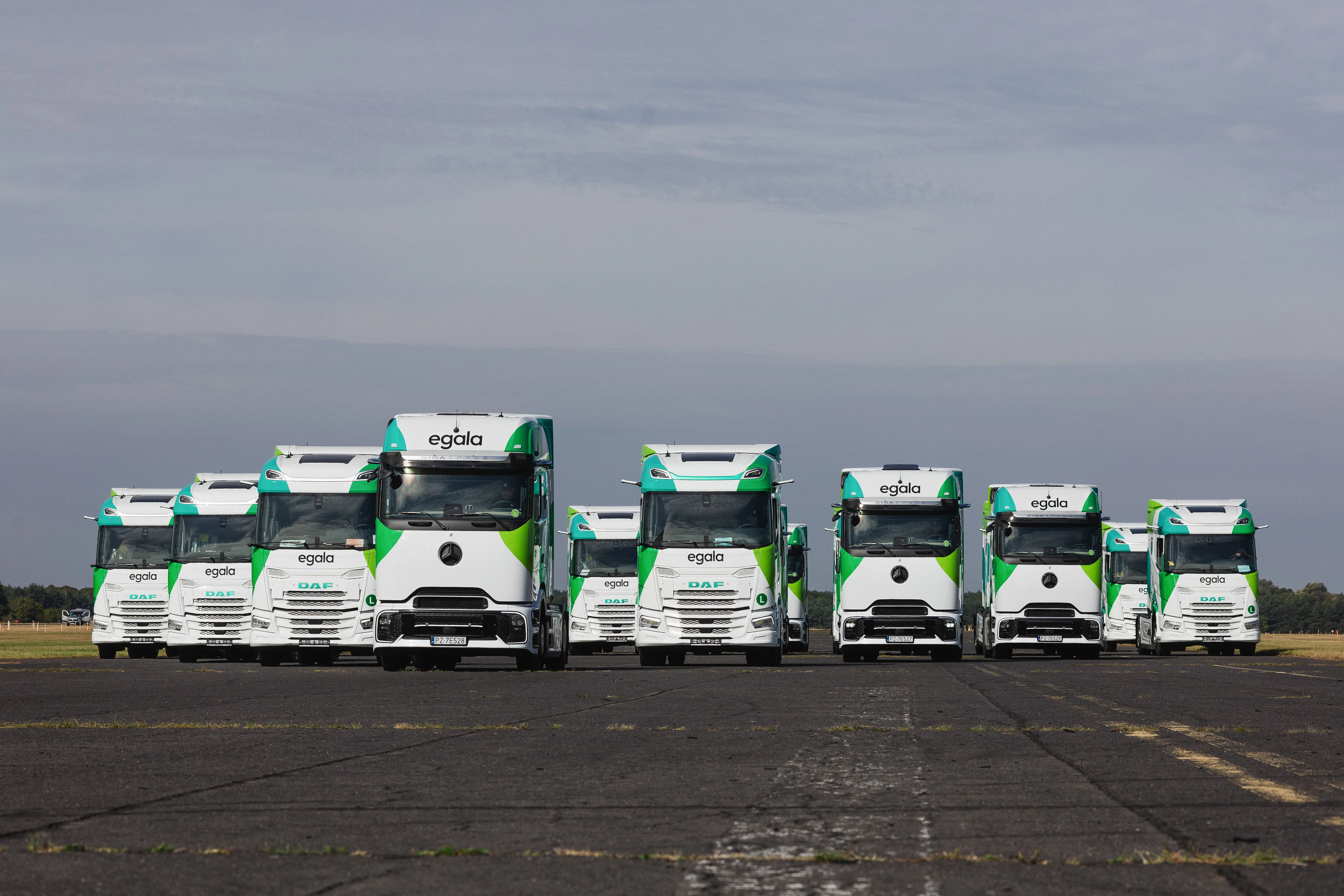 Fleet of Egala by Boekestijn electric trucks driving in formation, showcasing modern sustainable transport and eco-friendly logistics solutions in Europe.
