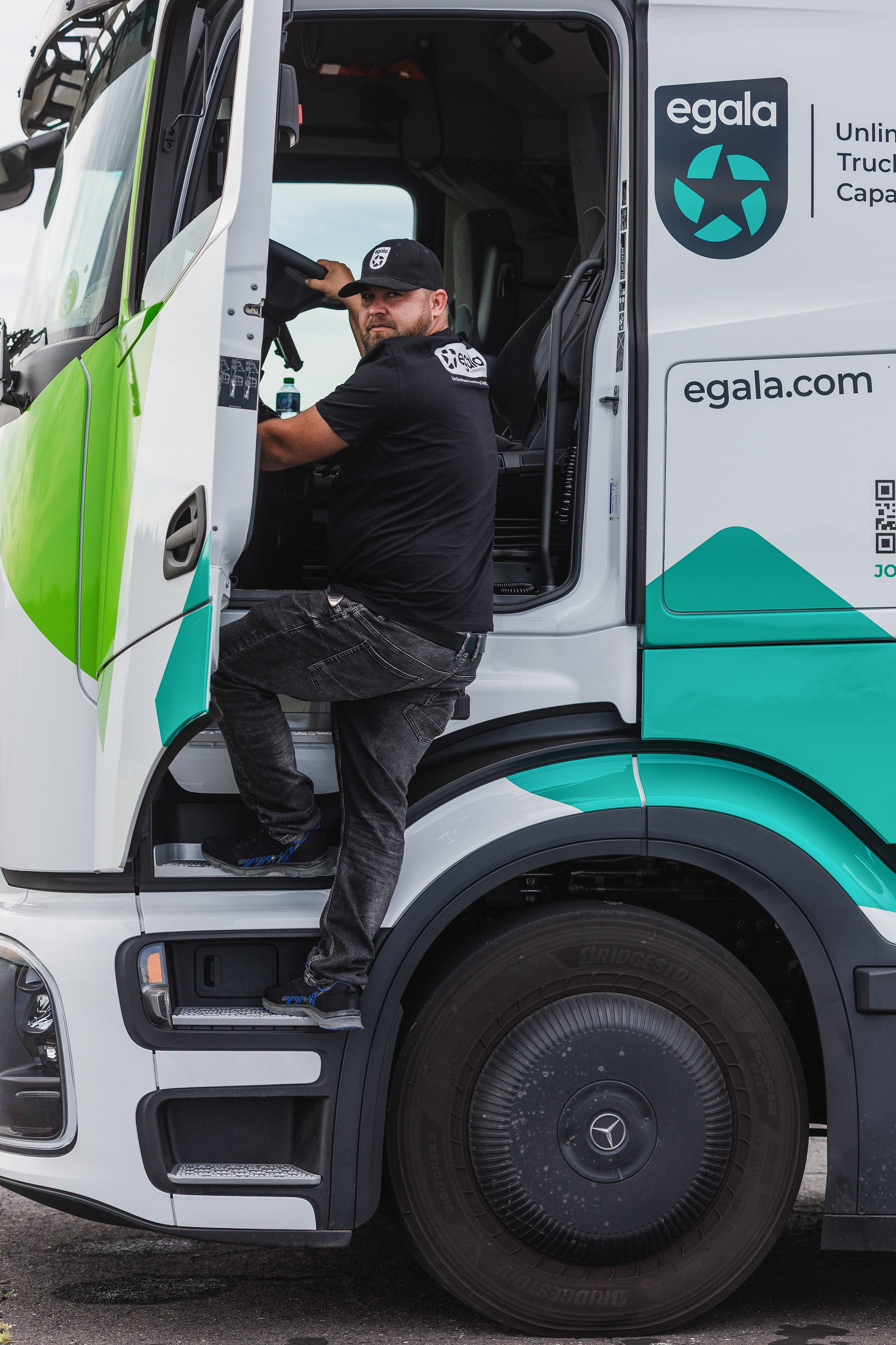 Professional driver stepping into Egala by Boekestijn electric truck, representing modern, sustainable, and people-focused logistics solutions