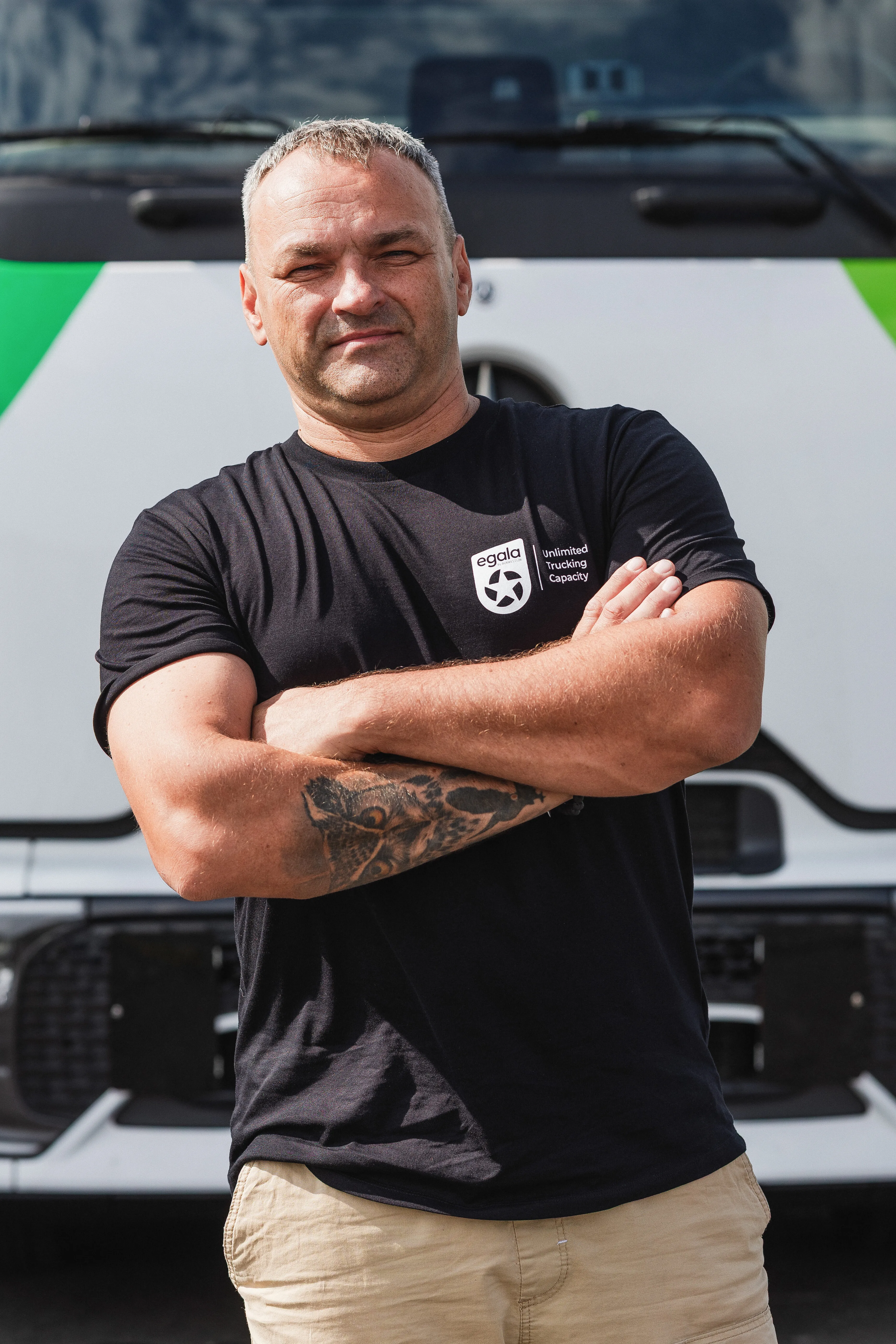 Egala by Boekestijn truck driver with folded arms — symbolizing confidence and pride in a diverse trucking workforce.