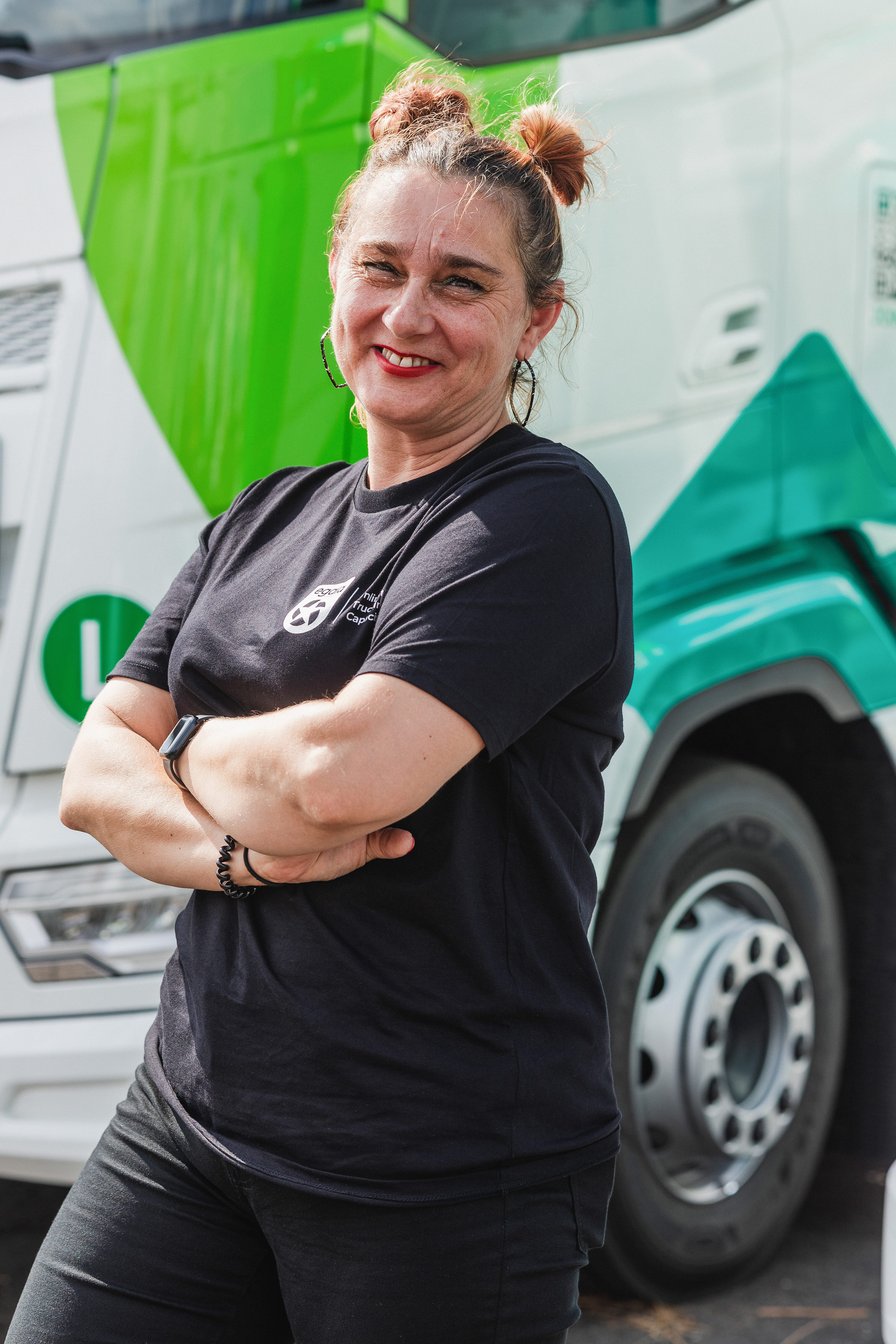 Egala by Boekestijn team member smiling in front of a truck — representing inclusion and diversity in European trucking