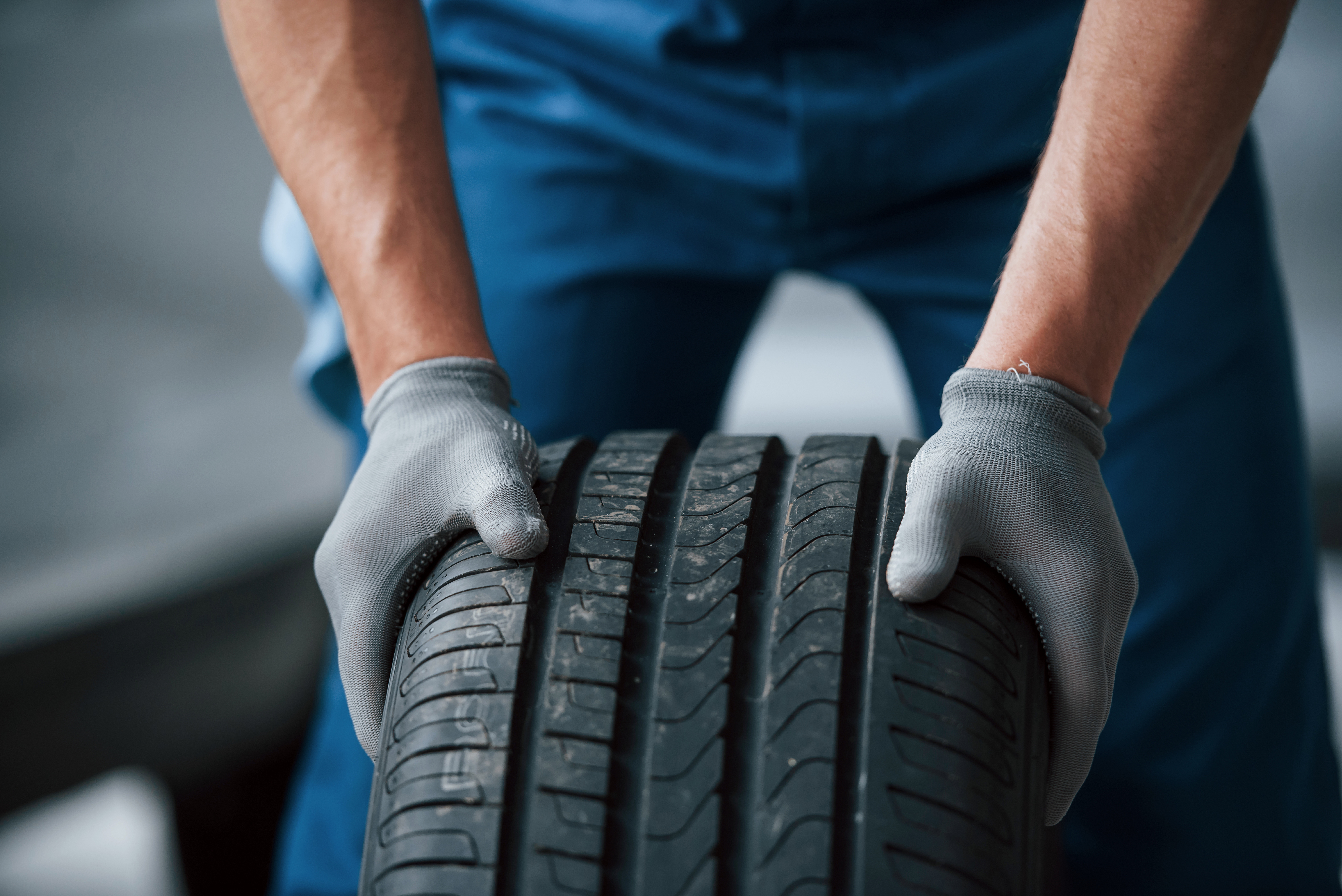 Mechanic holding a truck tire at Egala by Boekestijn — using recyclable components and materials to promote sustainability in trucking