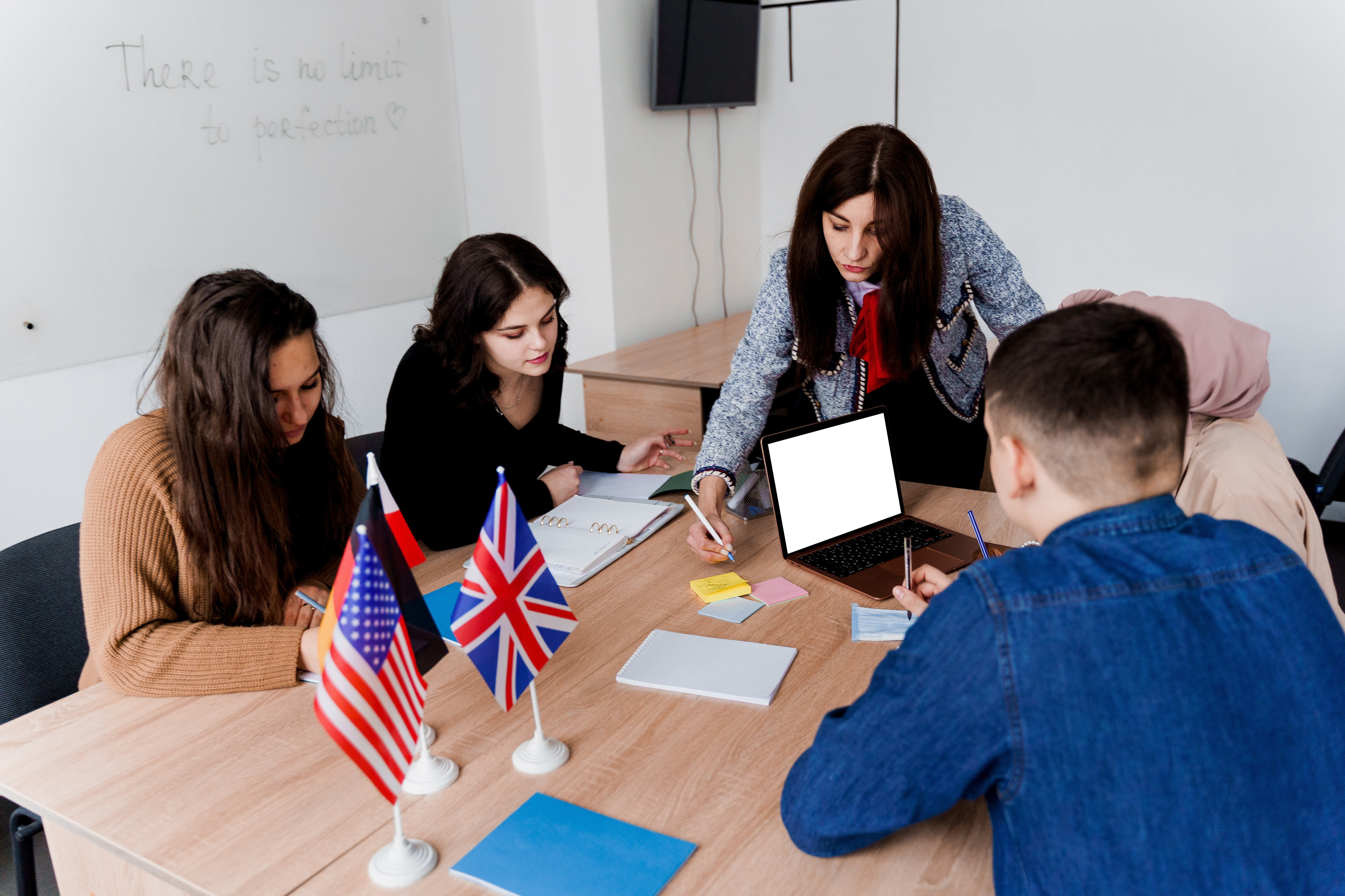 Group of people sitting around a table with UK and EU flags during a training session.