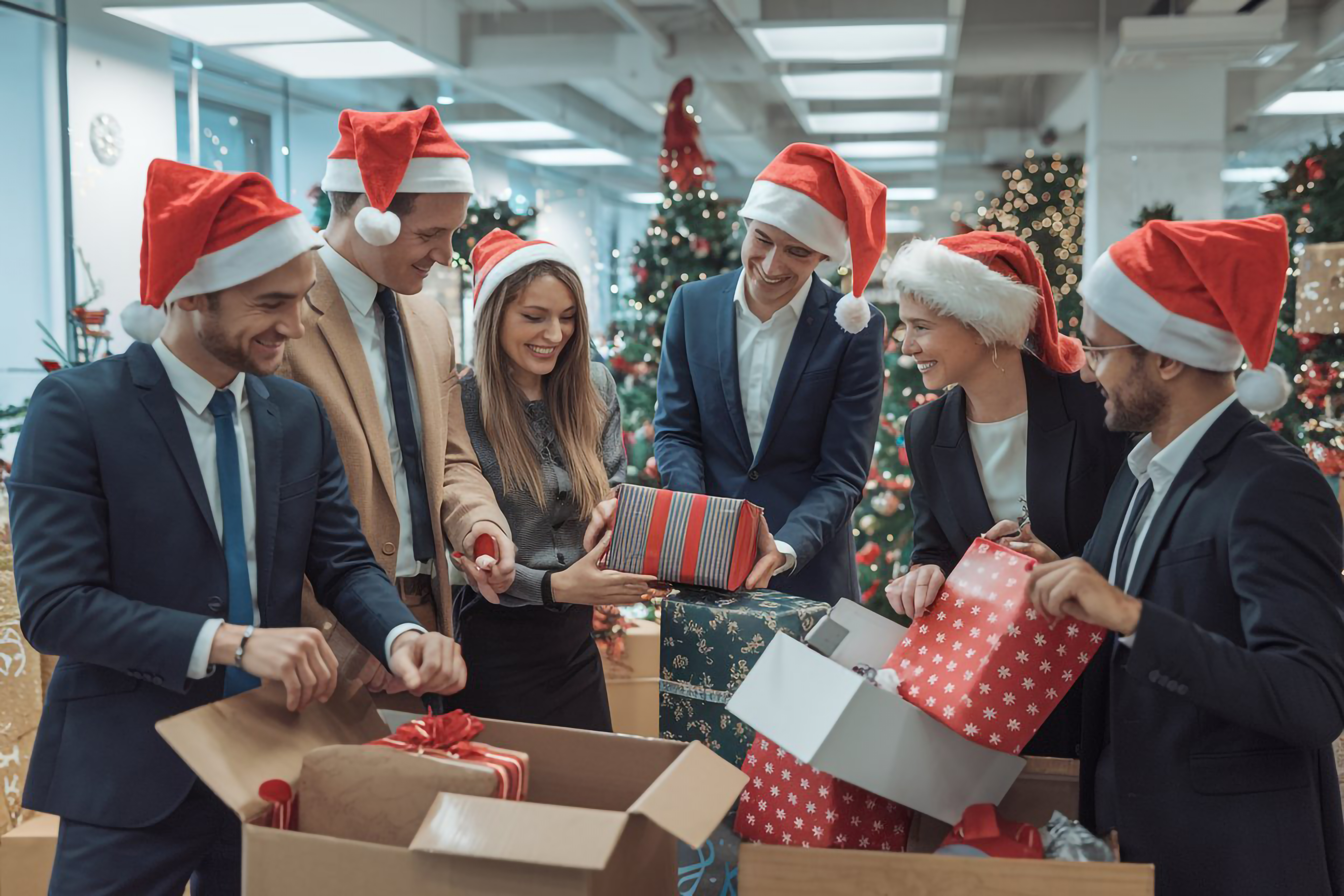 Egala by Boekestijn office team celebrating Christmas together, exchanging gifts and enjoying festive teamwork spirit during the holiday season.