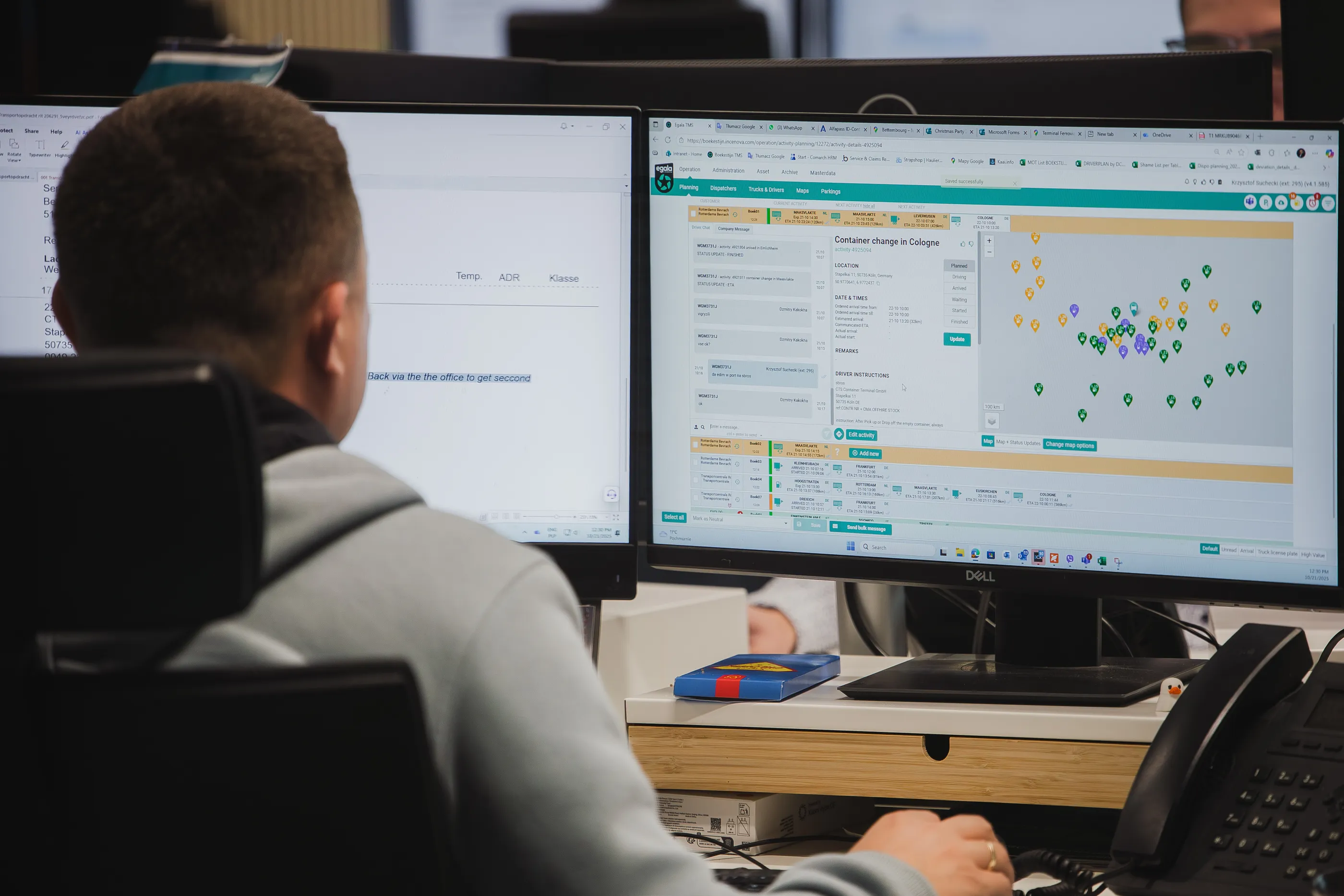Logistics operator at Egala by Boekestijn monitoring transport routes and shipment planning software on dual screens inside a modern operations control office.