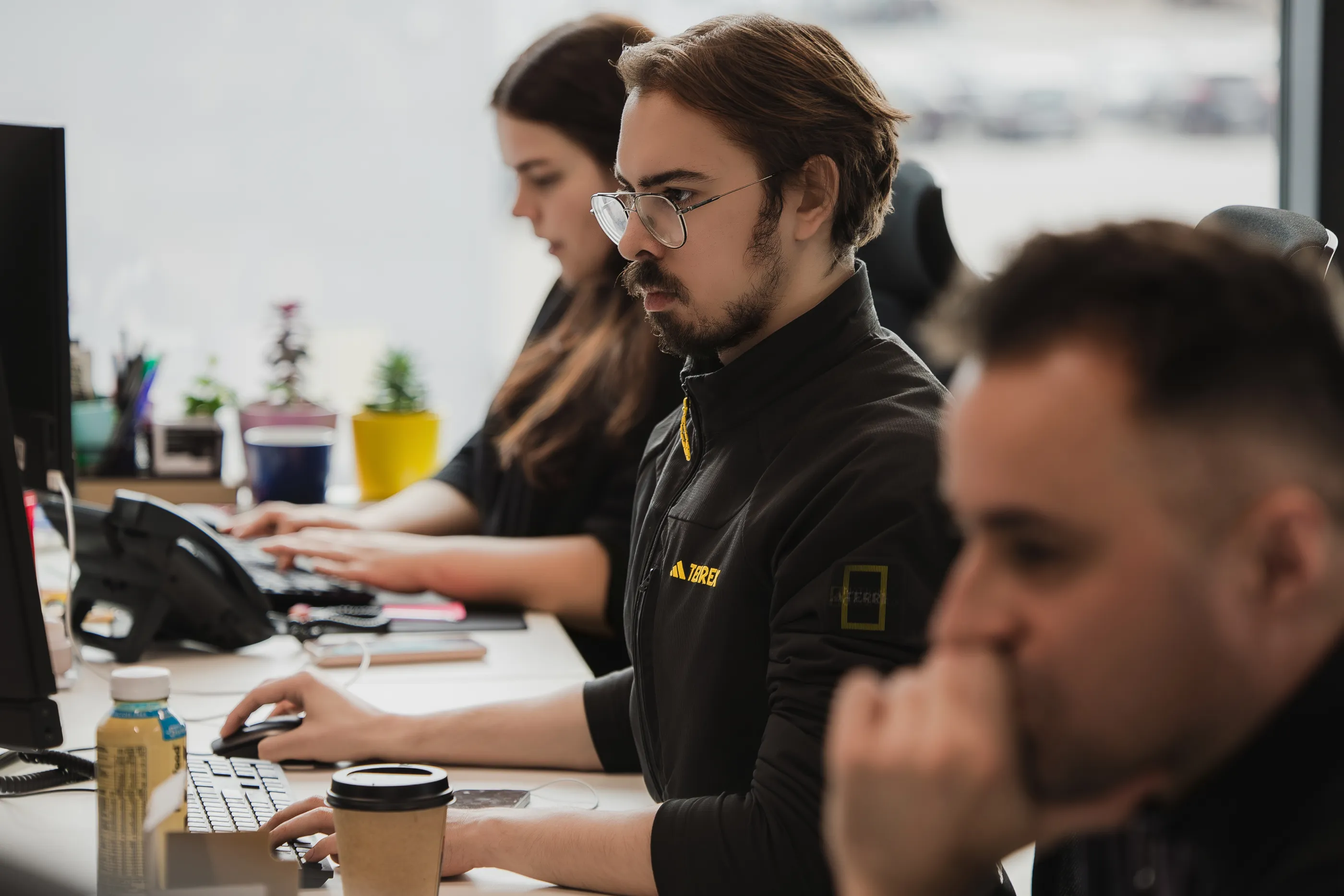 Egala by Boekestijn logistics coordinators working collaboratively in a modern operations office, focused on managing transport planning and customer service tasks at their workstations.