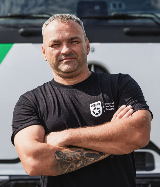 Egala truck driver with folded arms — symbolizing confidence and pride in a diverse trucking workforce.