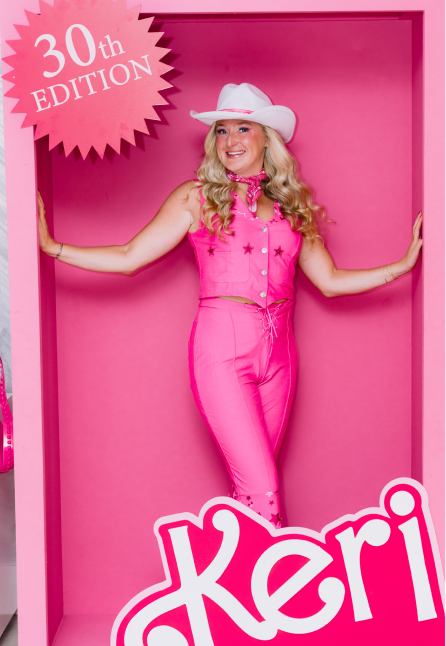 Smiling woman with long blonde hair dressed in a bright pink outfit and white cowboy hat posing inside a pink box frame with '30th Edition' text on top left corner.