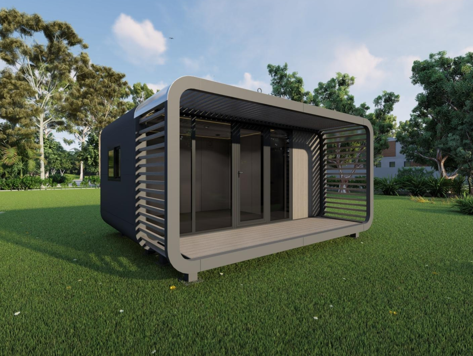 Modern small cabin with a covered wooden deck and glass sliding doors surrounded by green grass and trees.