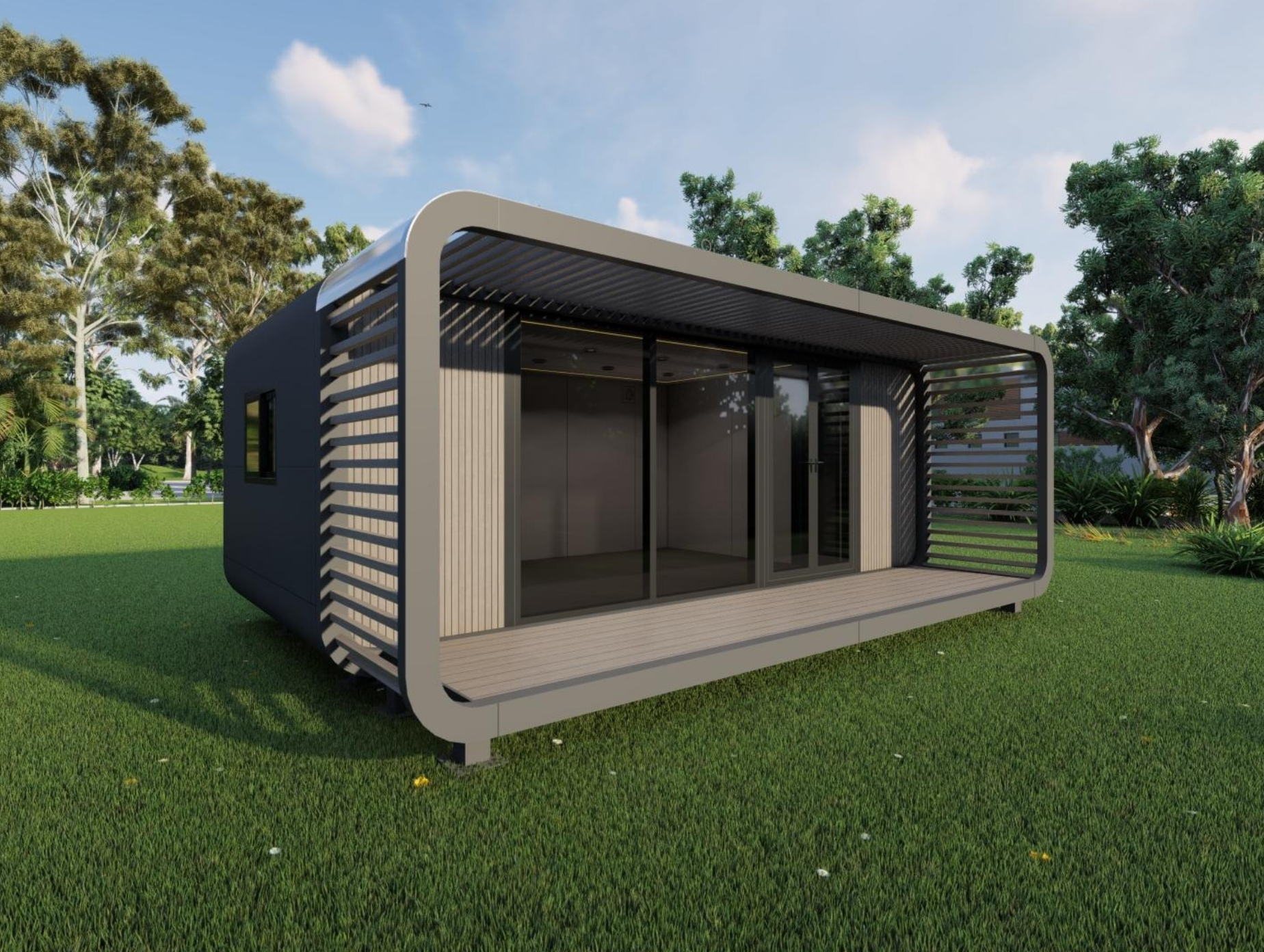 Modern small cabin with large glass sliding doors and a covered wooden deck surrounded by green grass and trees.