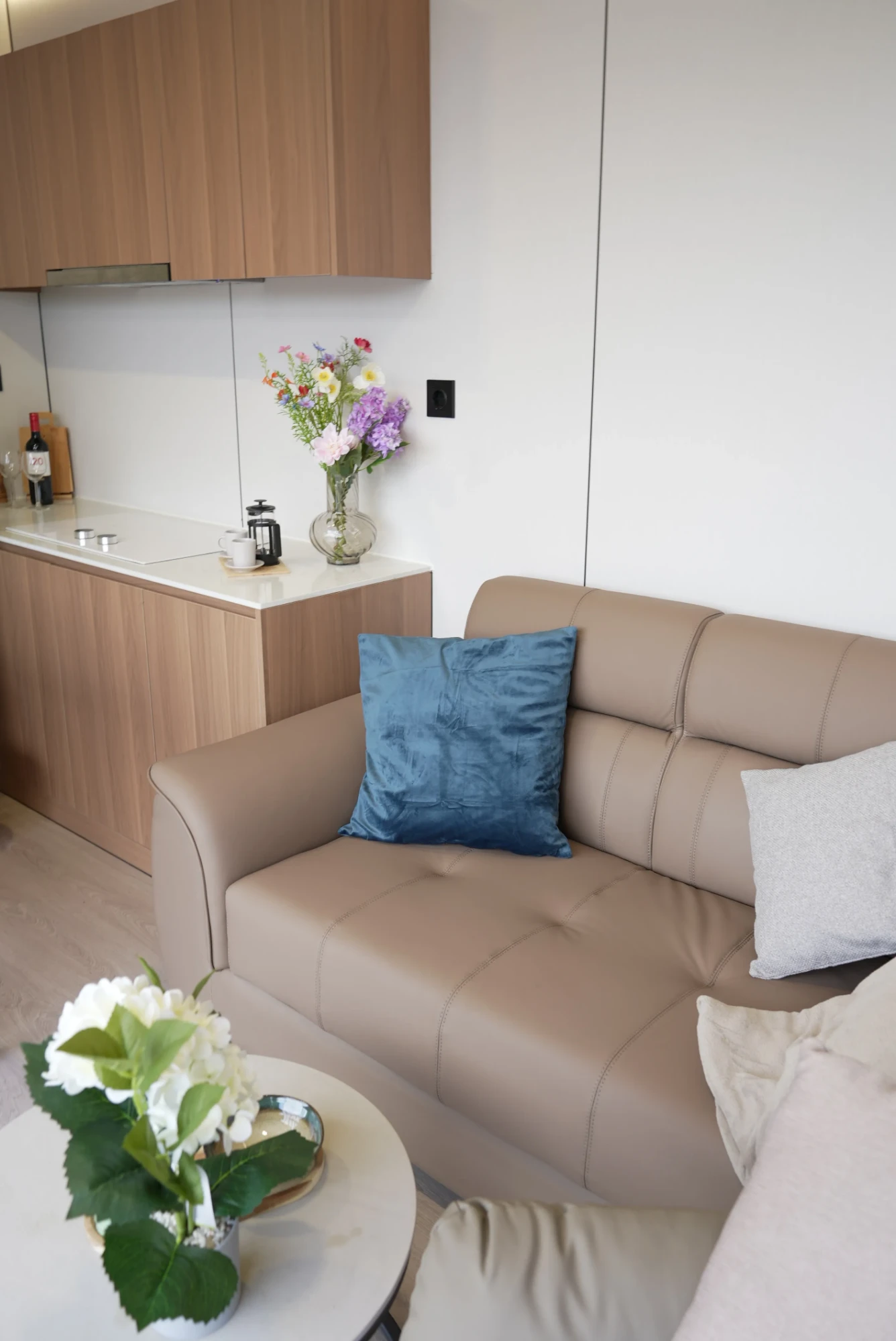Concept Modular interior with leather sofa, coffee table and fitted timber kitchen