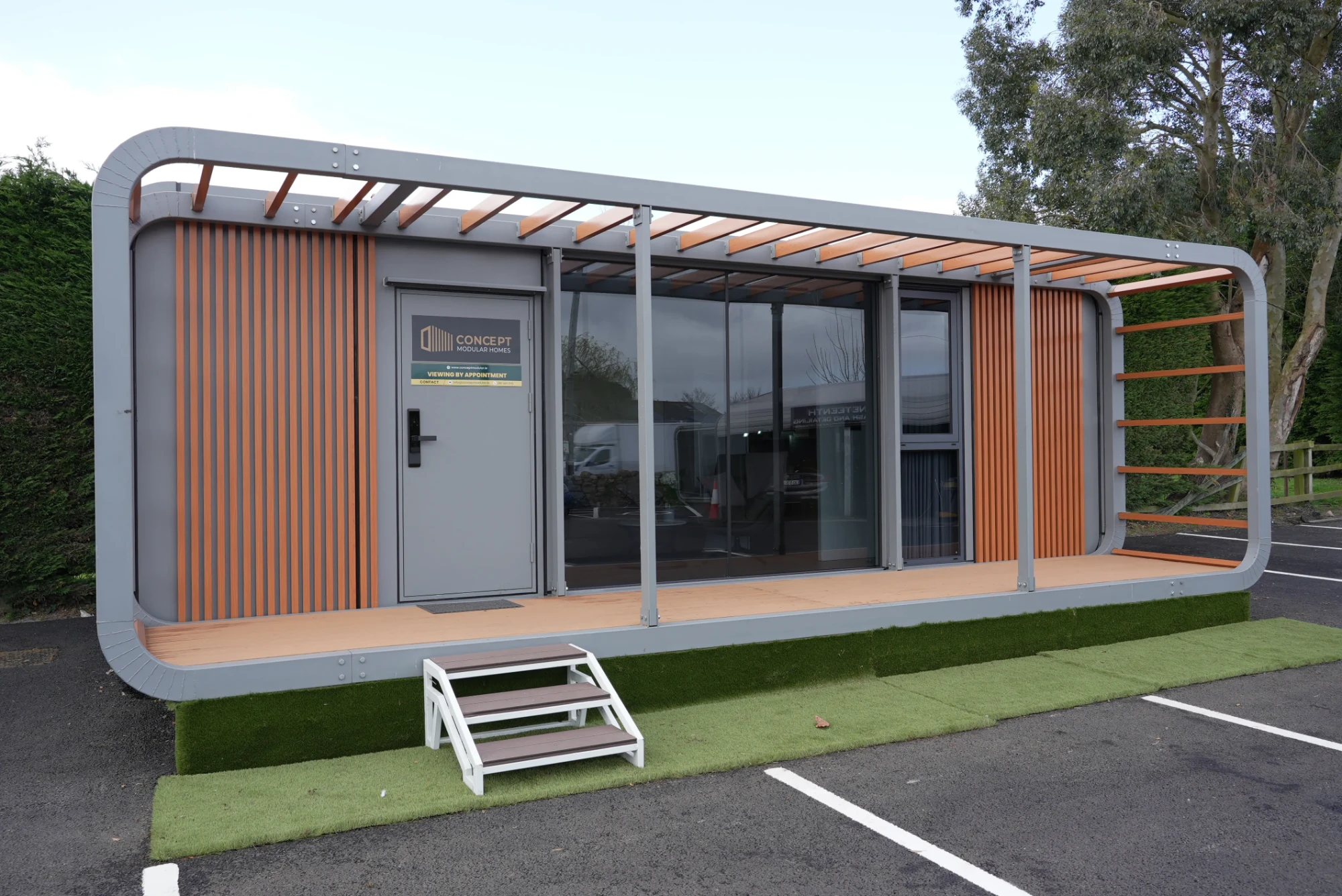 Concept Modular show unit with pergola roof, timber-effect cladding and decked terrace
