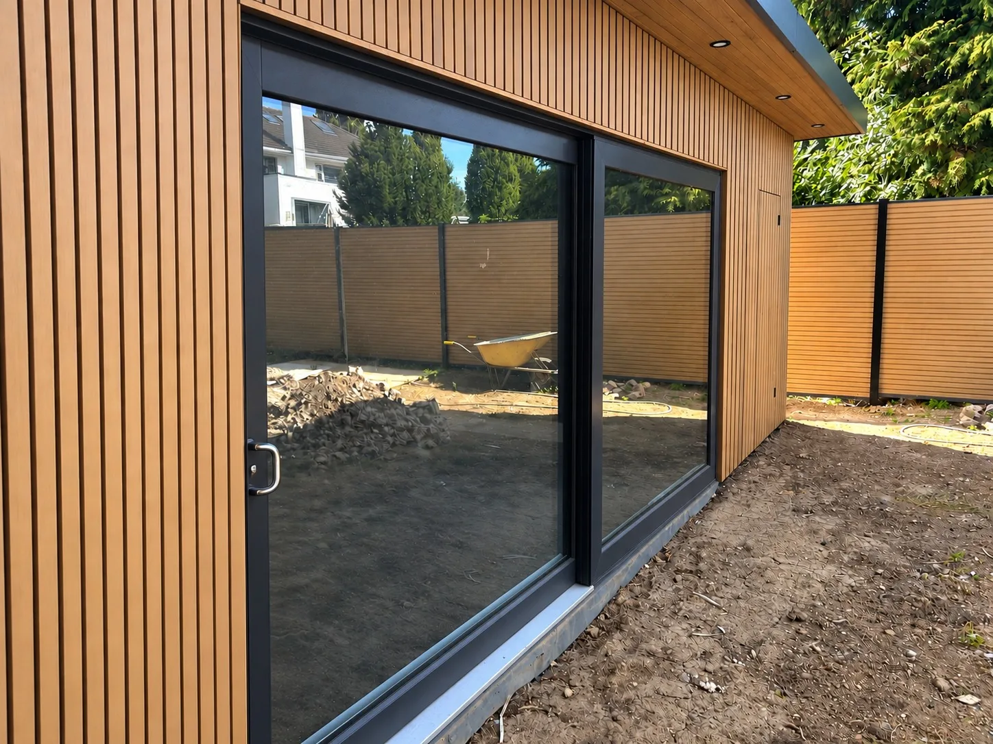 Composite cladding and aluminium sliding doors on a Concept Modular garden room