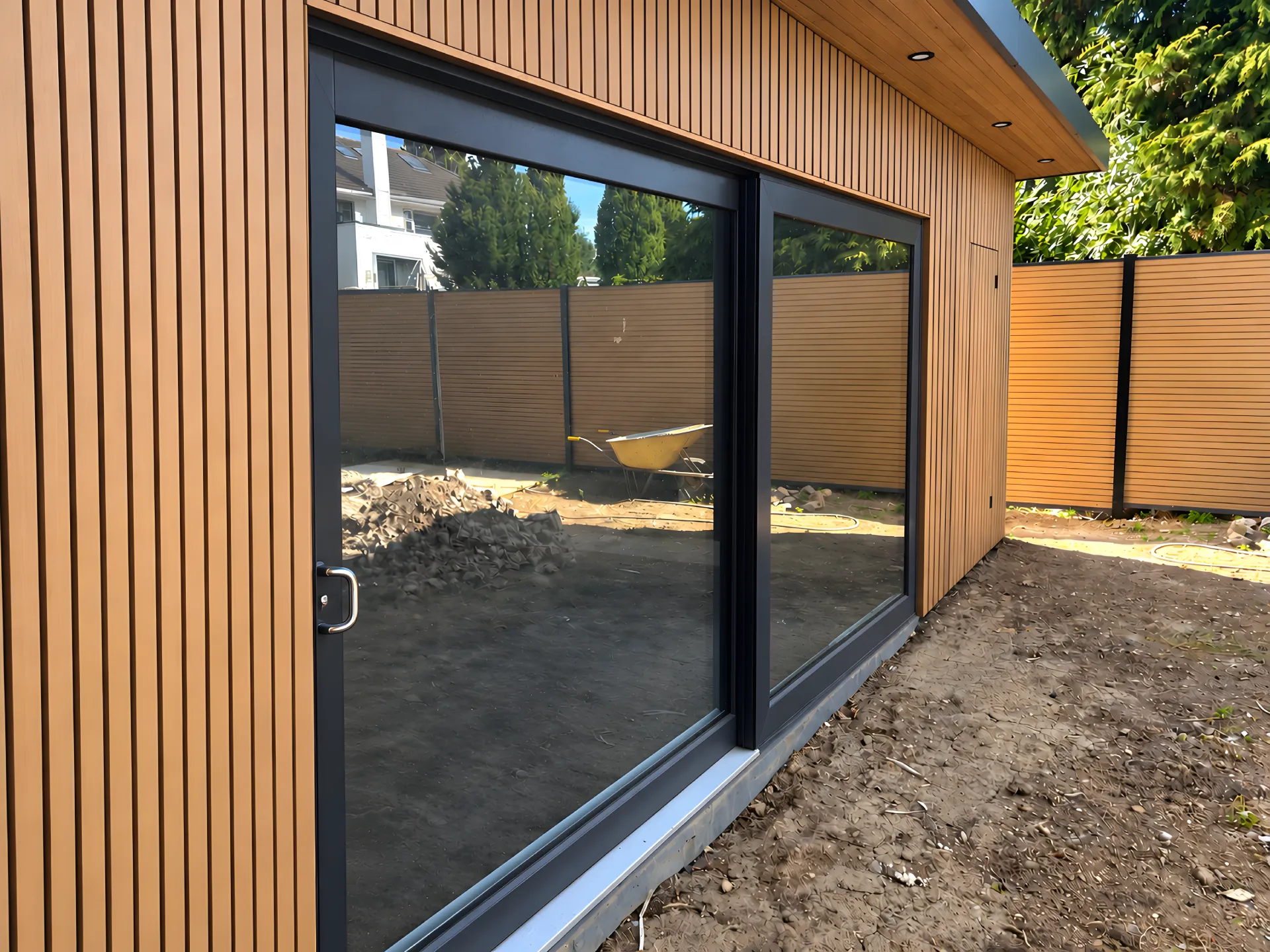 Bespoke garden room with vertical timber-effect composite cladding and large aluminium sliding doors