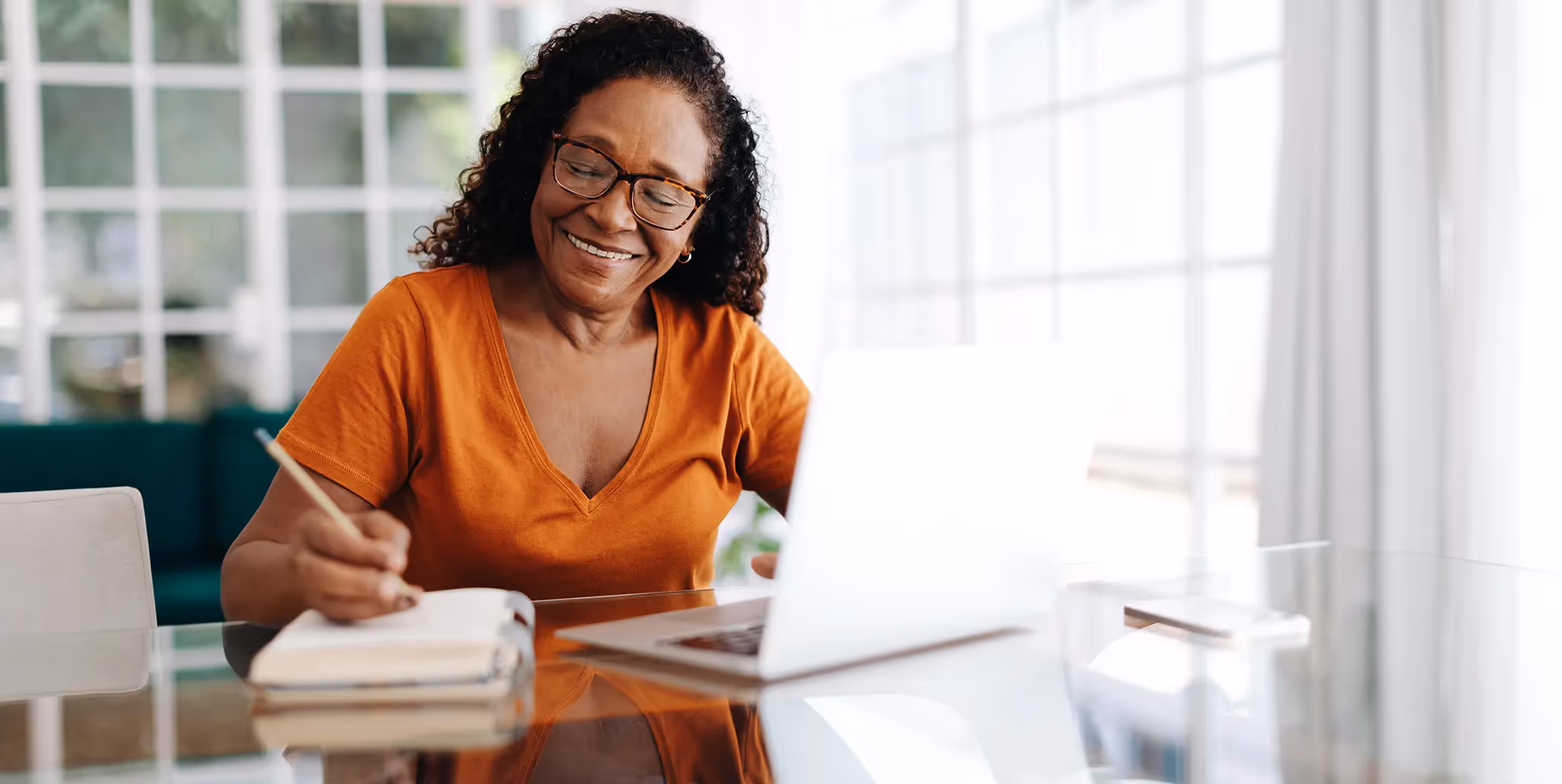Older woman smiling while working on her laptop