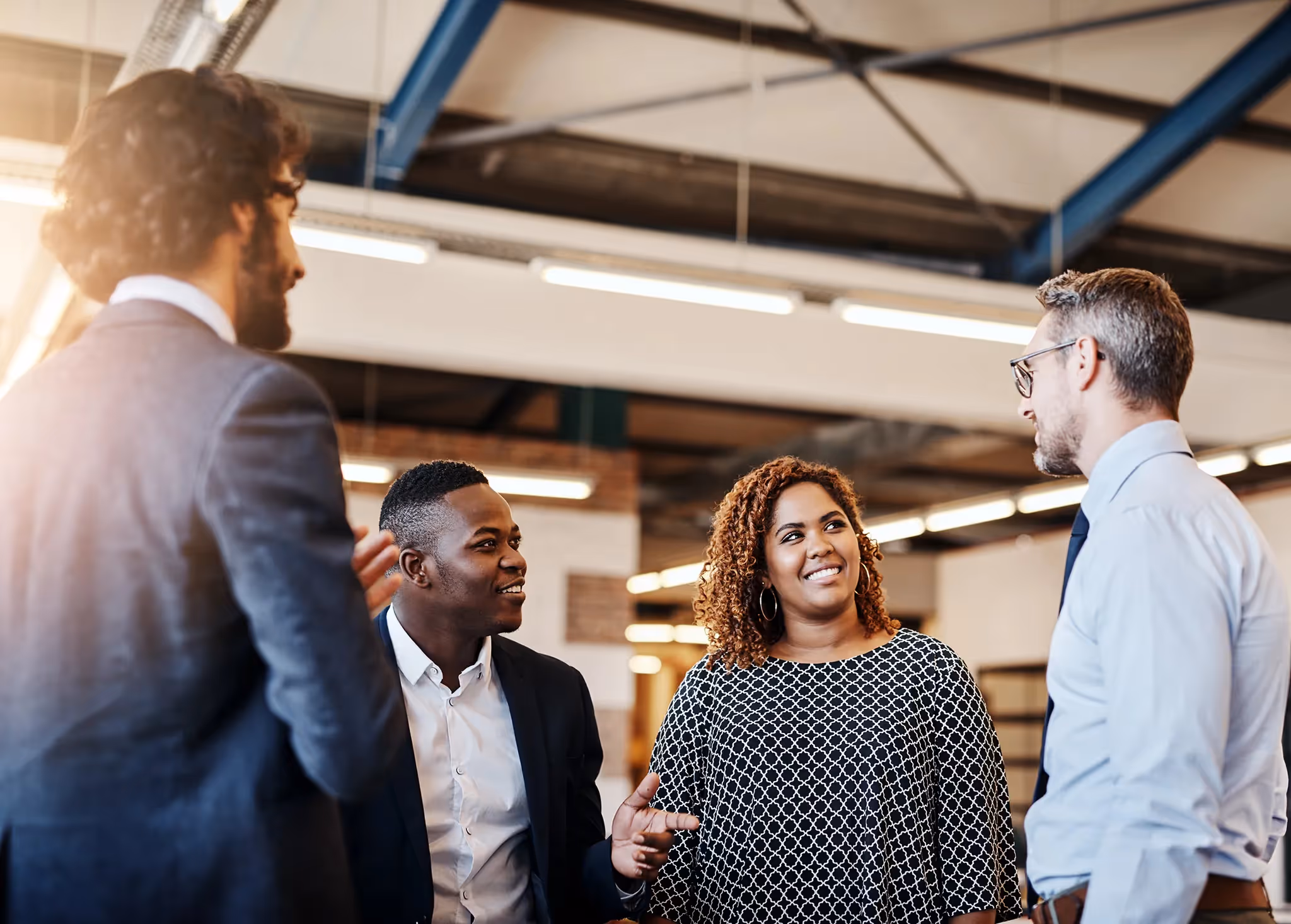 Business owner giving his team of advisors a tour of his warehouse