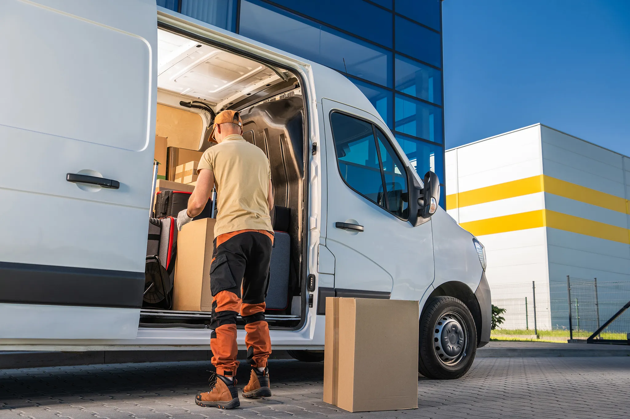 Courier standing in open door of his white transit van with text Related commercial insurance options