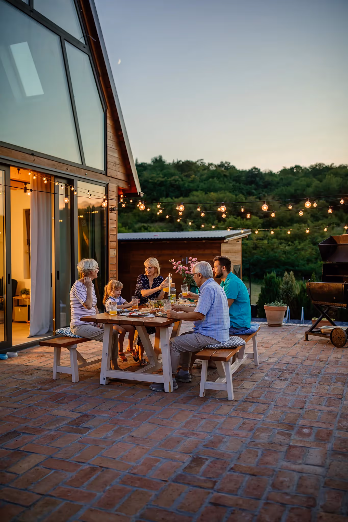Family get-together on patio at picnic table discussing Permanent Life Insurance options