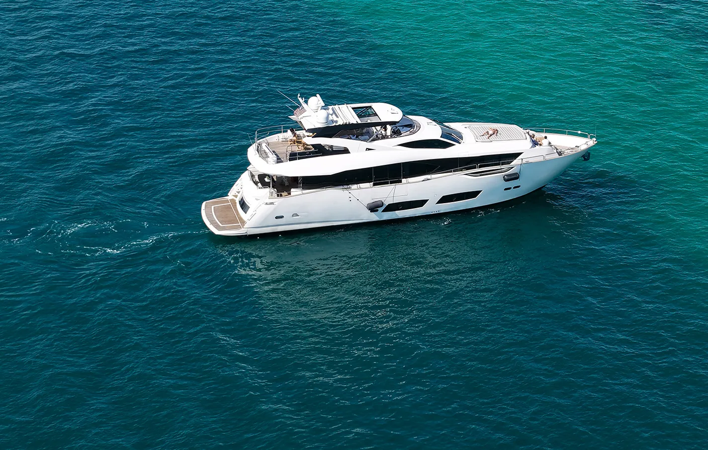 Luxury yacht in the ocean with text Marine and Super-Yacht