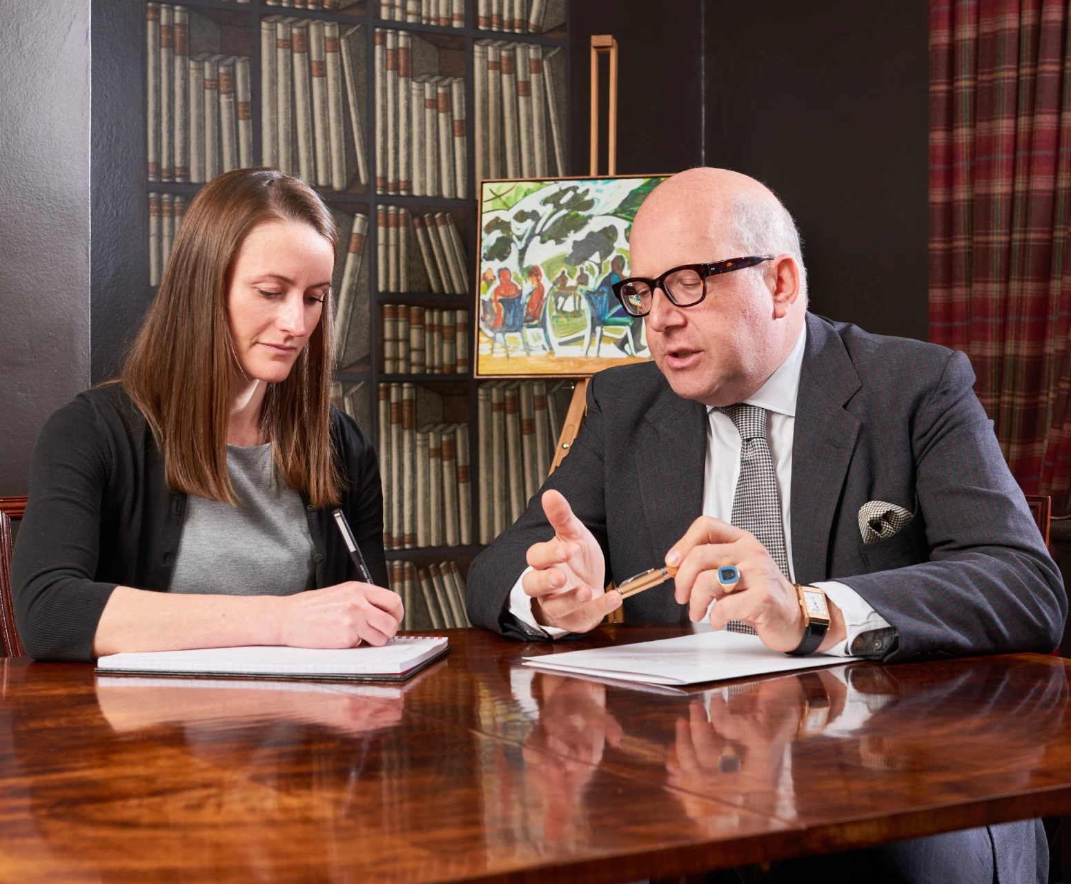 Two people discussing and writing notes