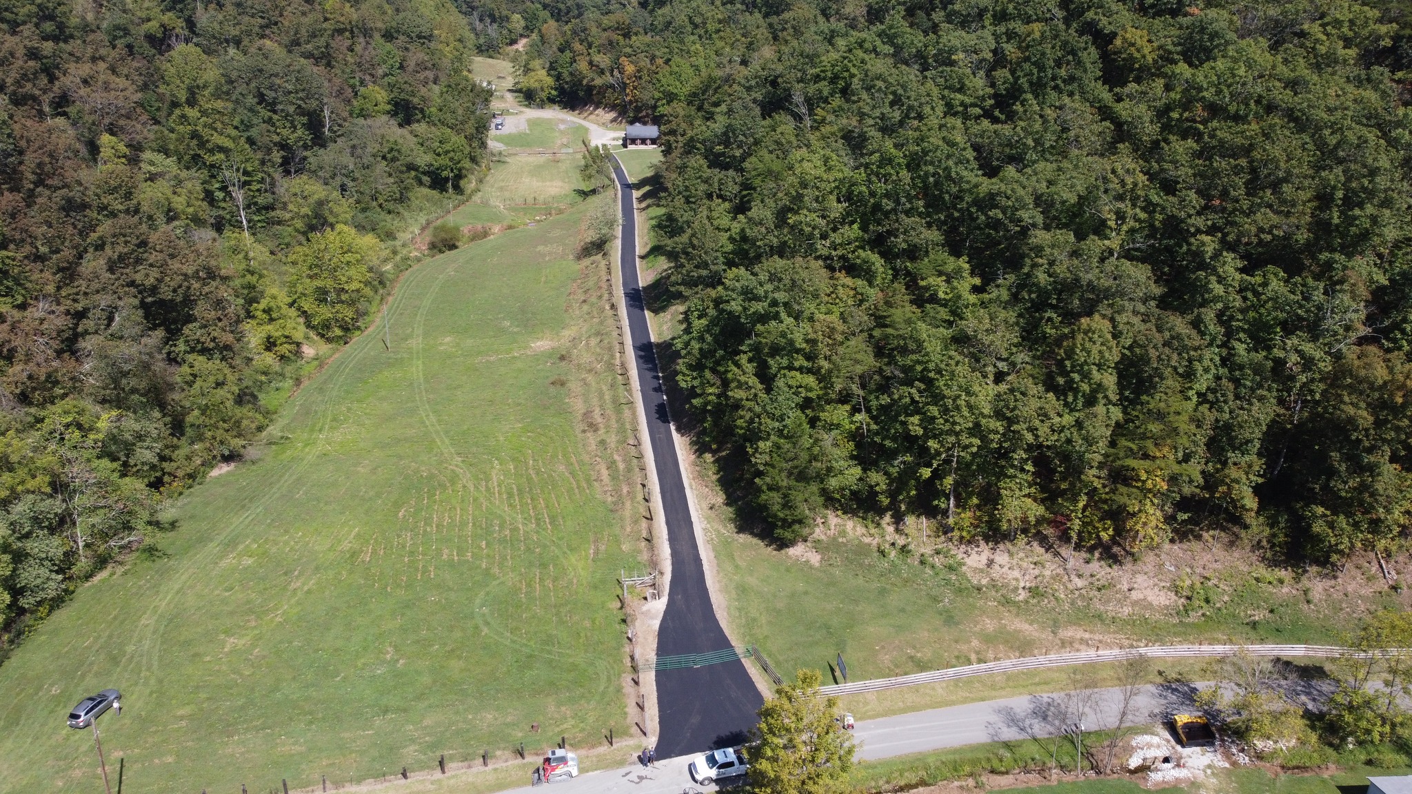 An empty field beside a newly paved road.