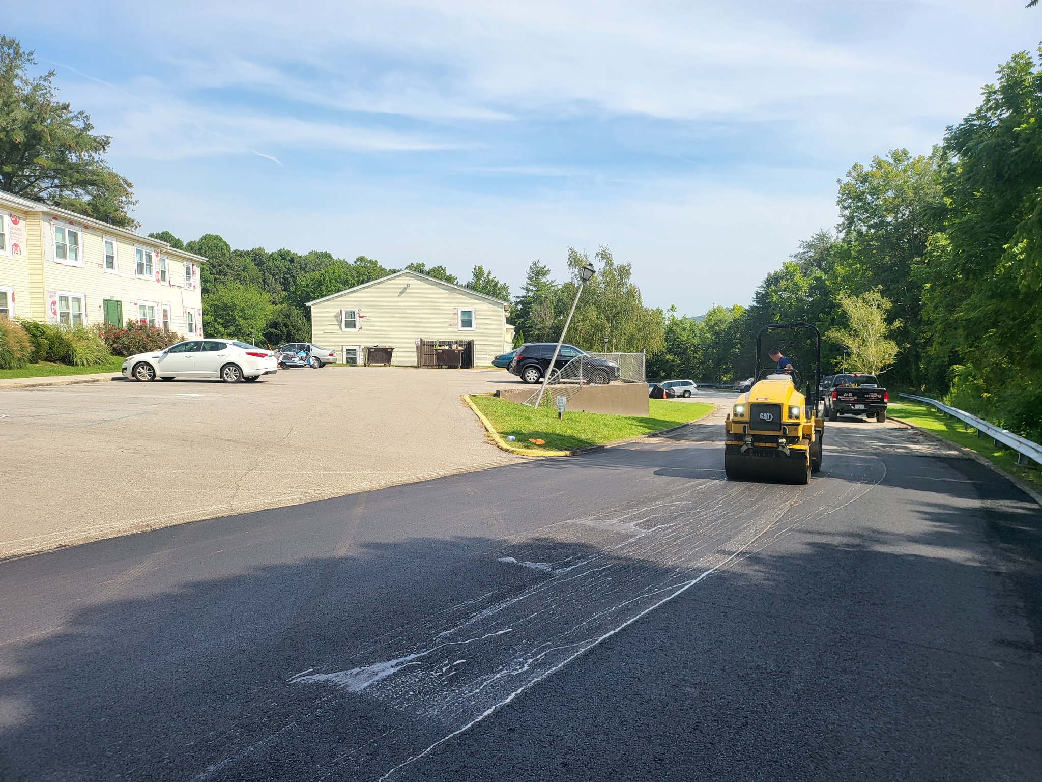 A paving job in progress in an apartment complex parking lot.