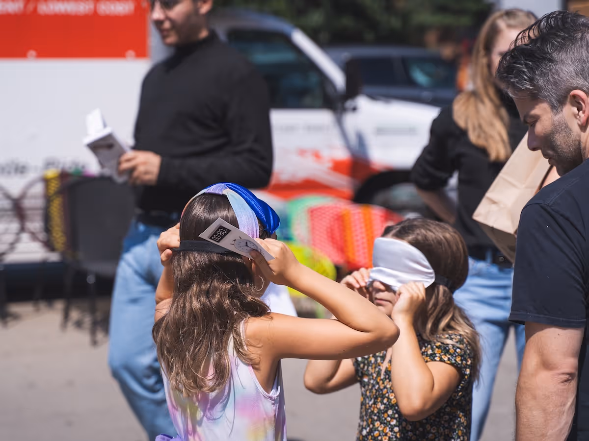 2 young girls trying on the sleep masks