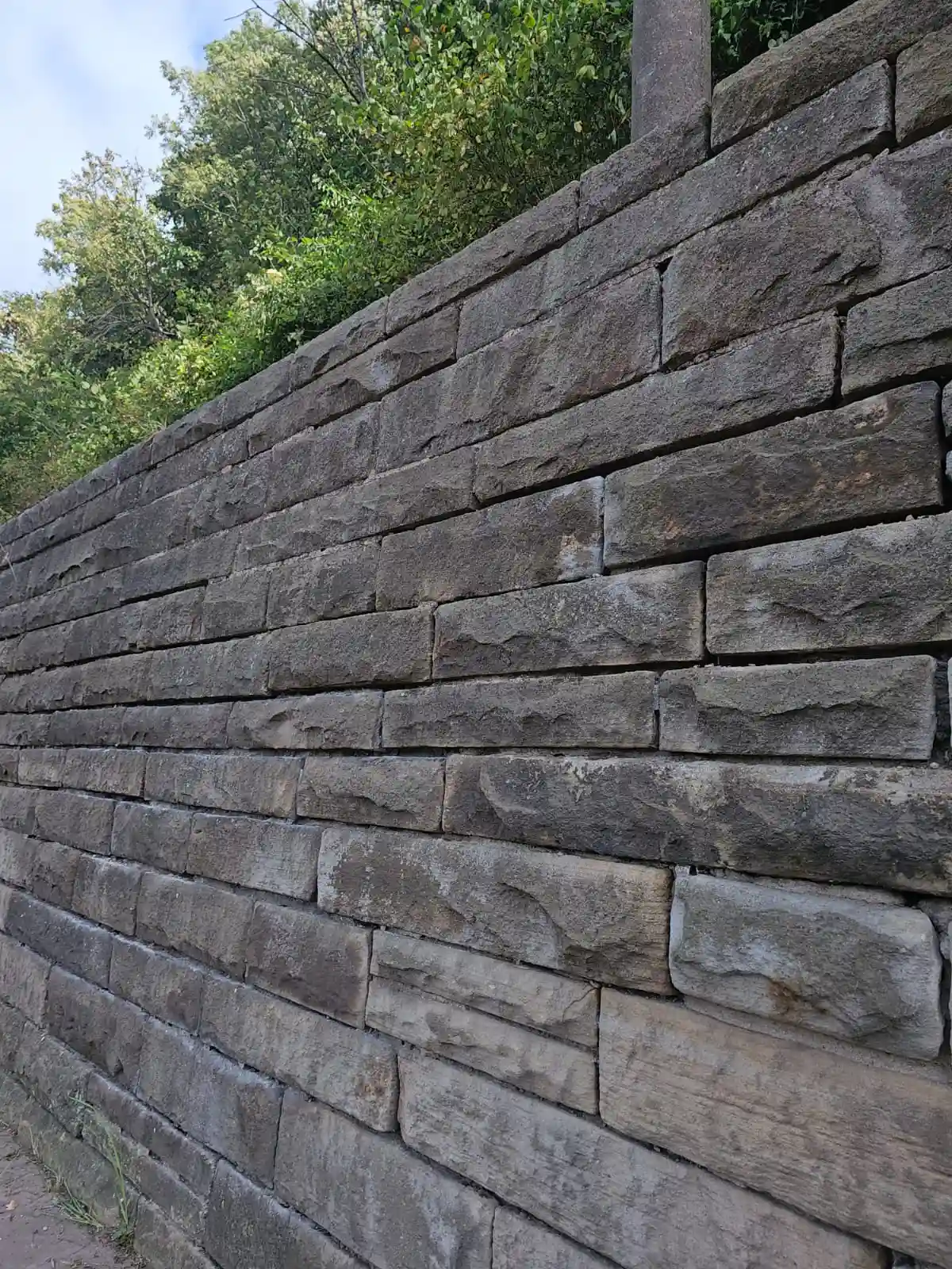 Seitenansicht einer Wand aus dunkelgrauen Klinkersteinen