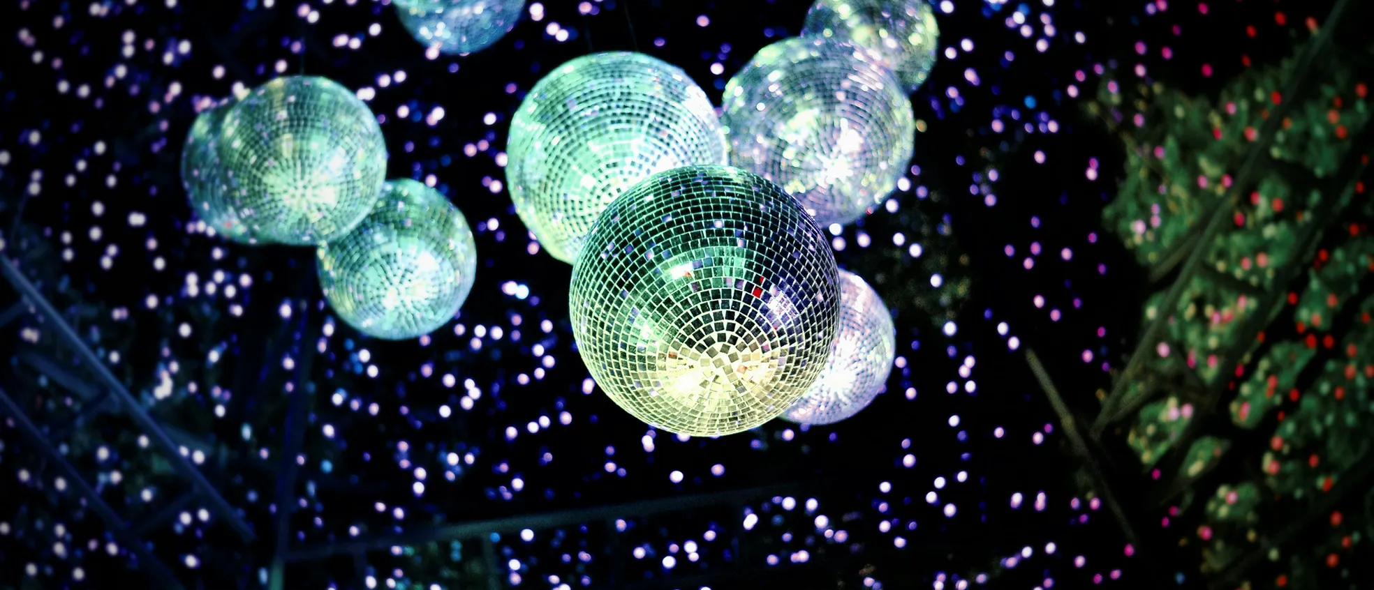 Disco ball reflecting colorful lights at a vibrant Portland event by Paradym Events