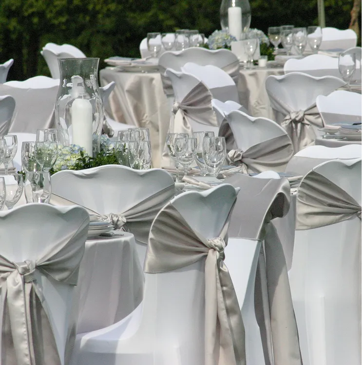 Custom chair wraps and detailed table settings styled for themed events by Paradym Events