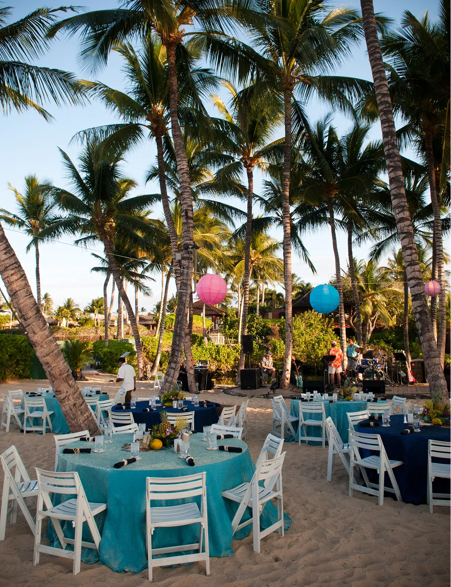 Outdoor Hawaii event with tropical lanterns and pineapple centerpieces styled by Paradym Events