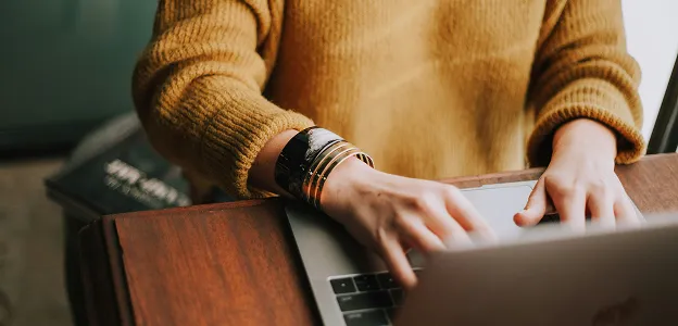 Woman filling out an event inquiry form on her computer for Paradym Events