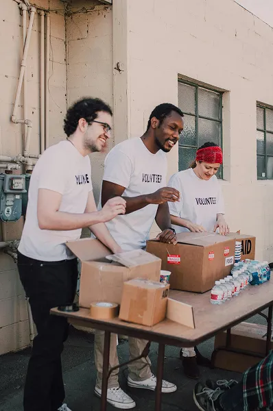 Volunteers distributing food donations to community members in need