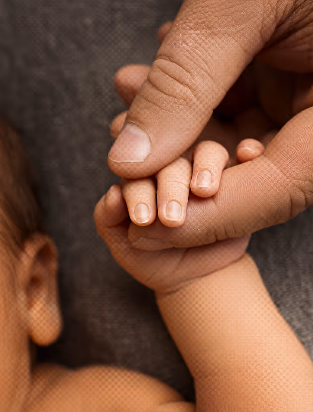 Father's hand holding his son's hand