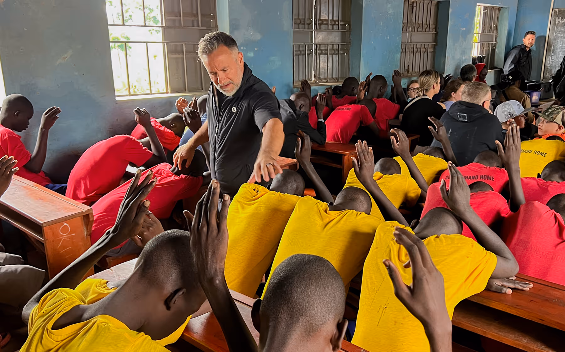 Dustin Sample prays over a class in an African school