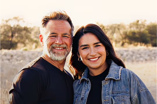 Dustin Sample smiling outdoors with his daughter, reflecting his role as a loving father.