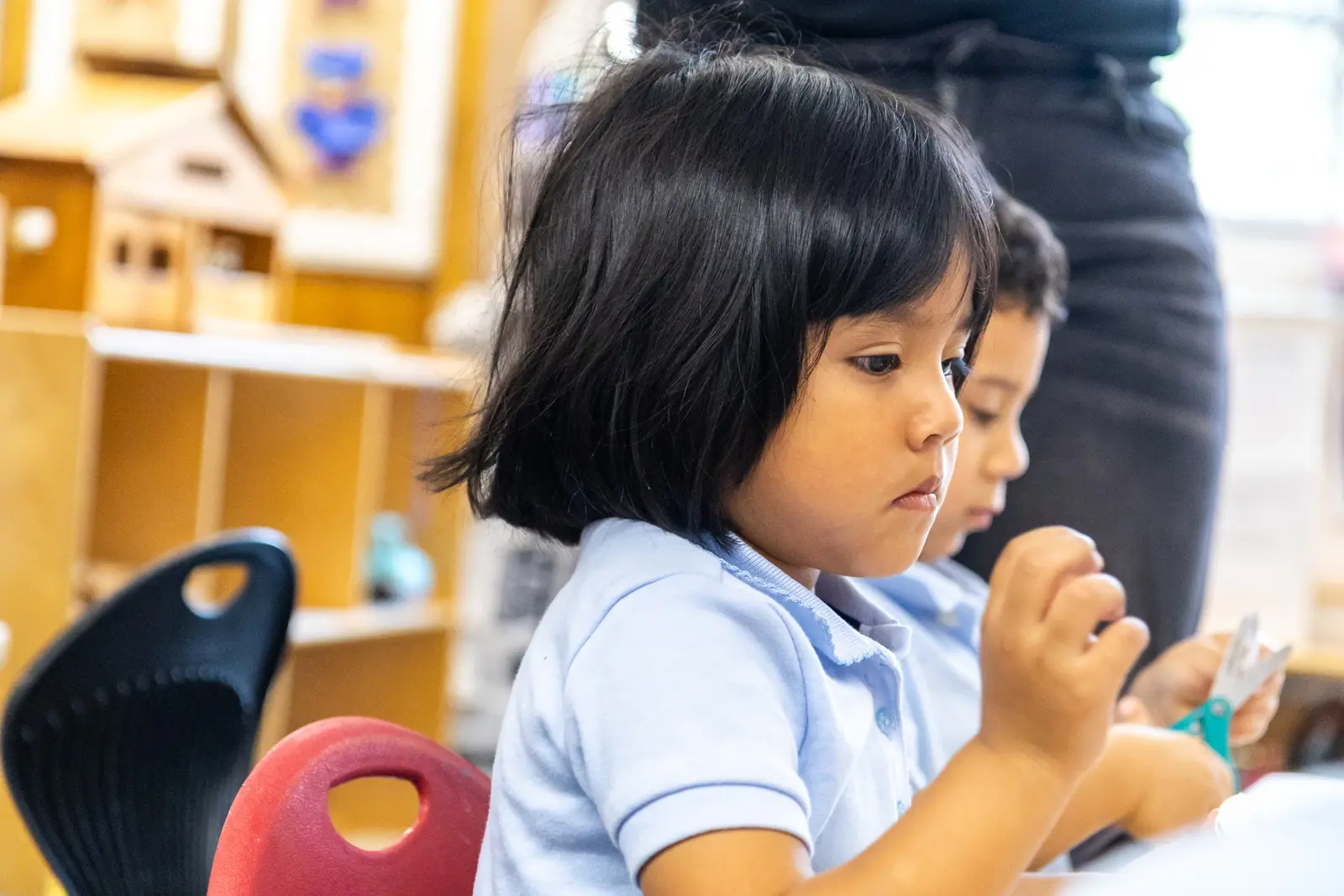 Young students in uniform focused on a classroom activity