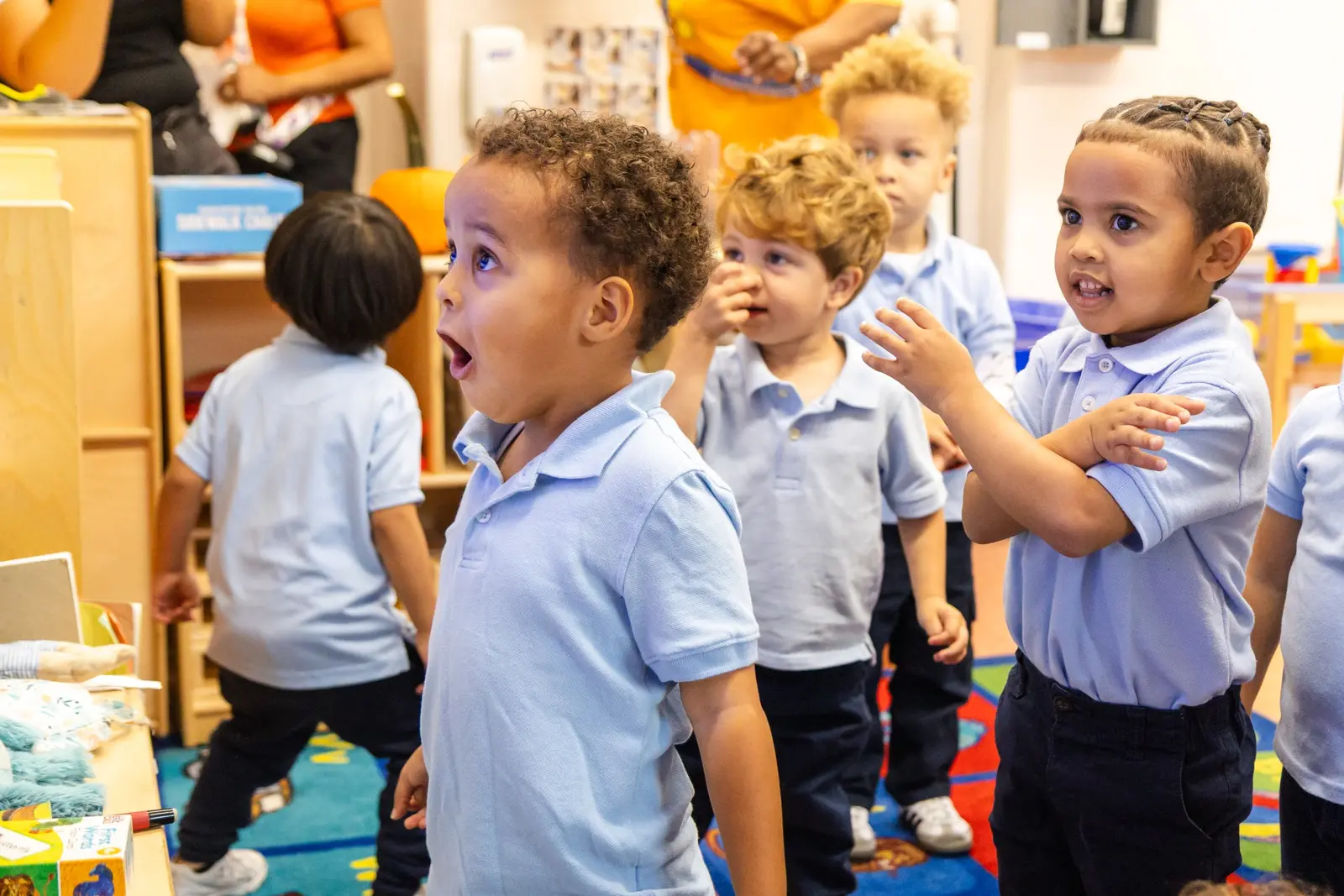 Young students in uniform polo shirts engaged in classroom activity