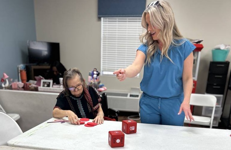 Nurse playing dice game with patient