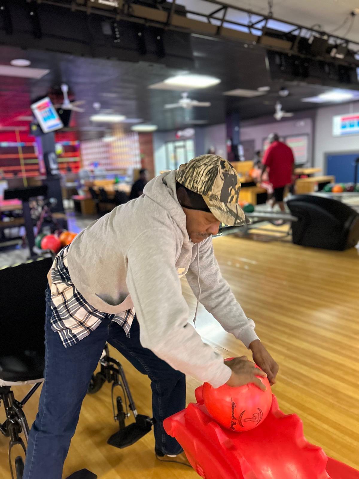 Resident rolling a bowling ball