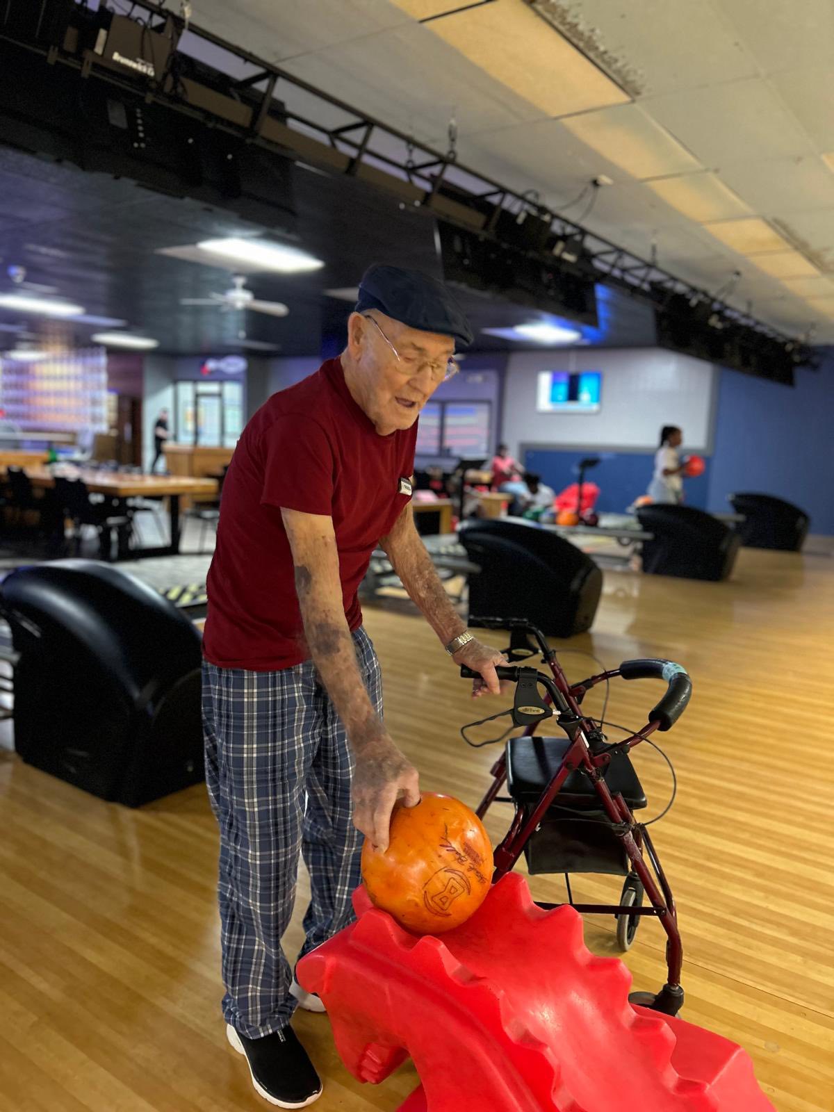 Resident rolling a bowling ball