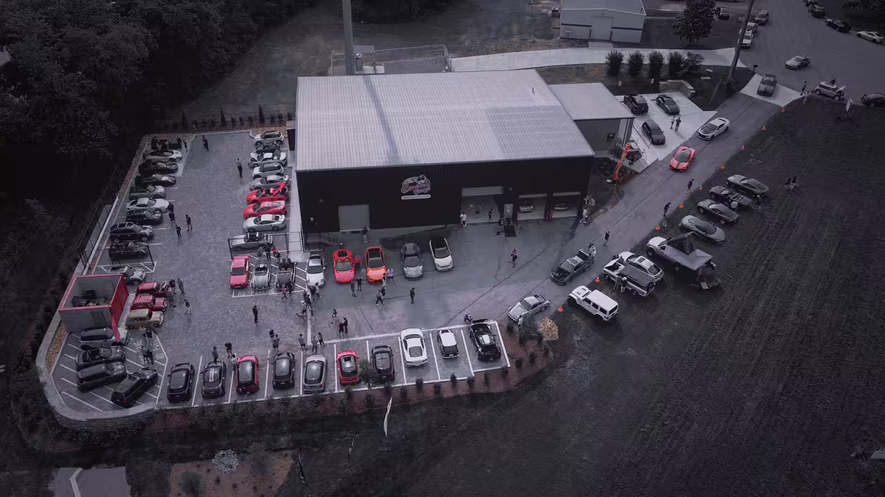 Crowd gathering around a full lot of cars at Cooper’s Garage Cars & Coffee