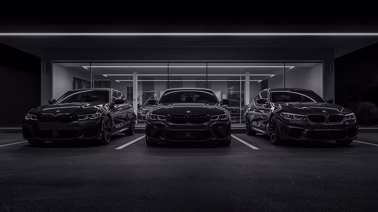 BMW M-series and 3-series lineup parked outside a European repair shop