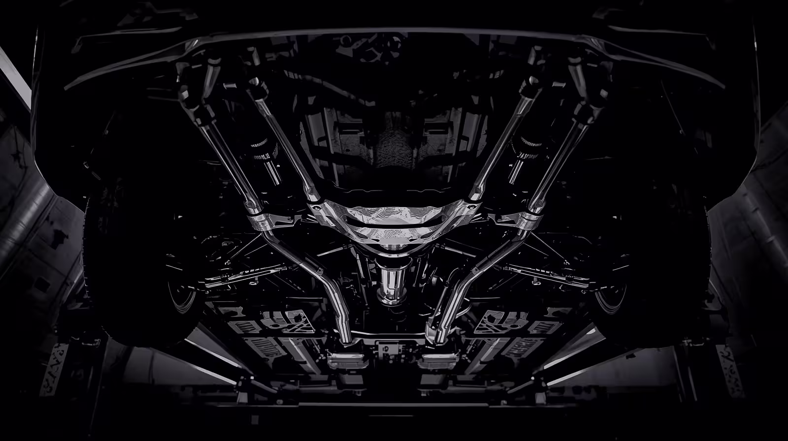 Undercarriage of BMW on lift showing rear suspension and differential