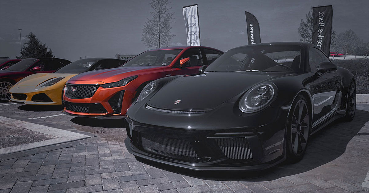 European sports cars parked at Cooper’s Garage during morning Cars & Coffee meet