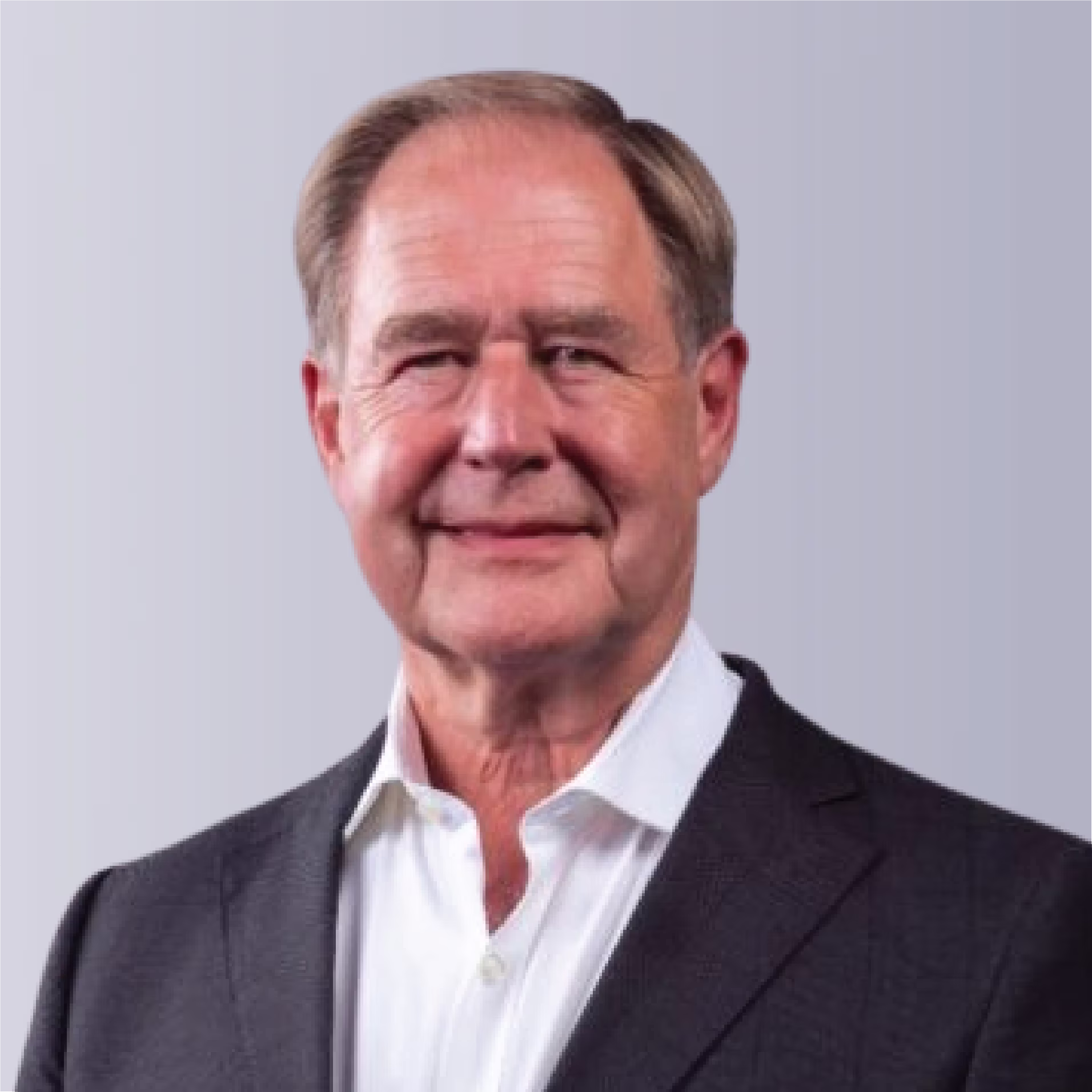 Two professionals shaking hands outdoors, symbolizing partnership and collaboration.